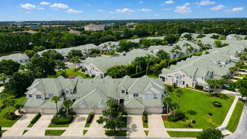 Prestigious gated community featuring expansive manicured lawns, mature landscaping, and elegant architectural design