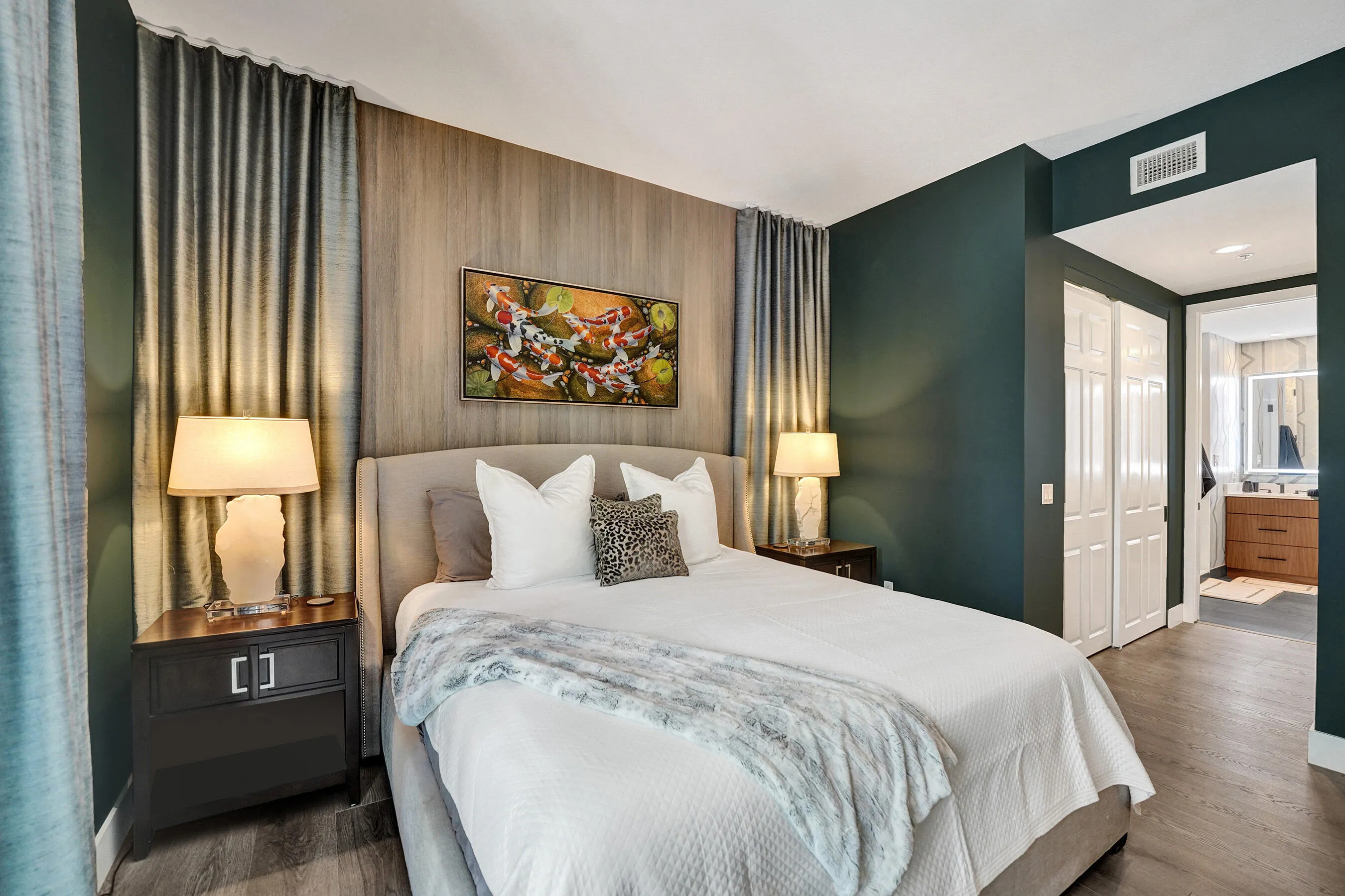 Wood-finish flooring, accent wall, built-in closet with bi-fold doors, and recessed lighting
