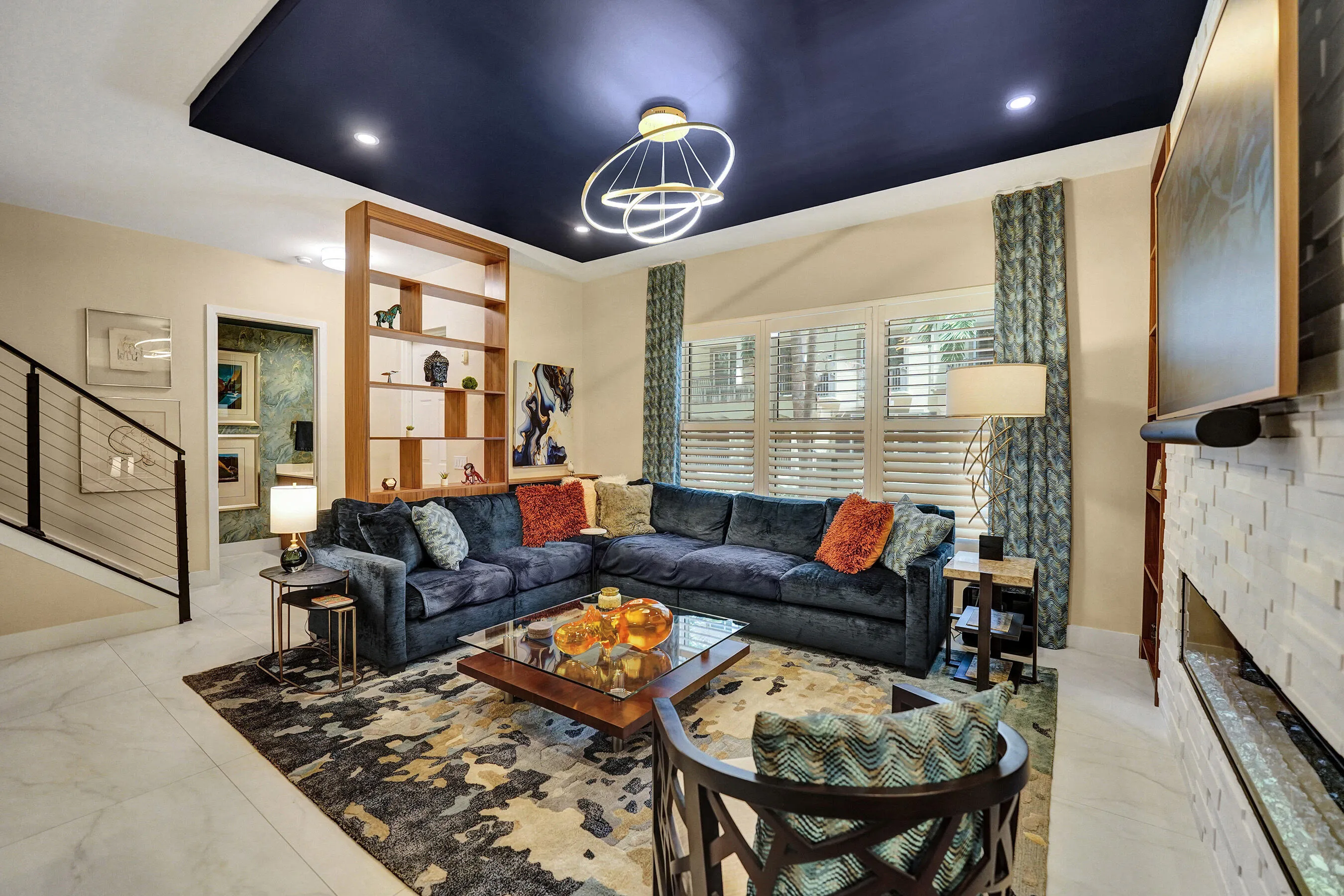 Recessed lighting and a dark-painted coffered ceiling