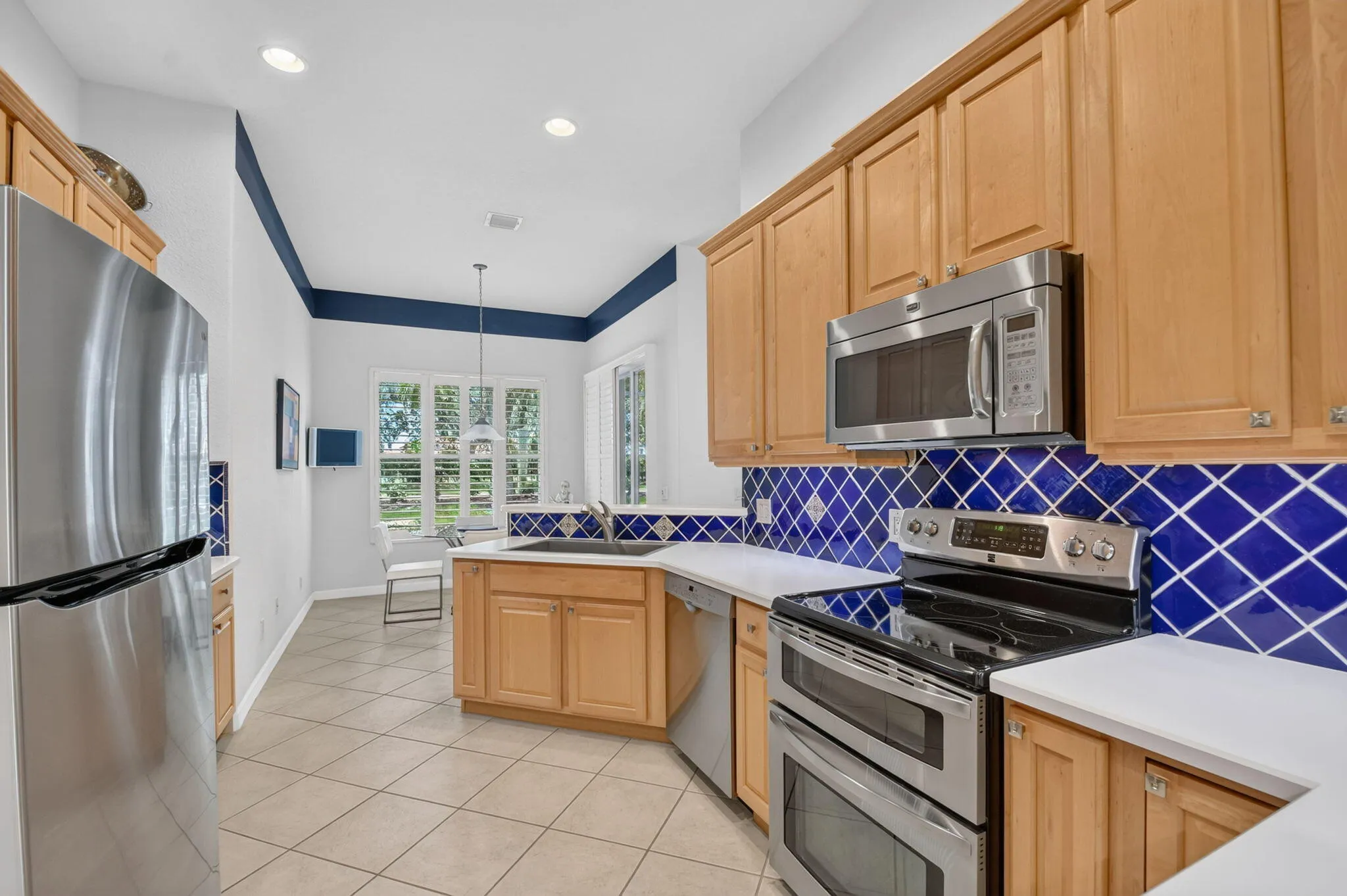 Wood panel cabinetry-full tile backsplash-stainless appliances