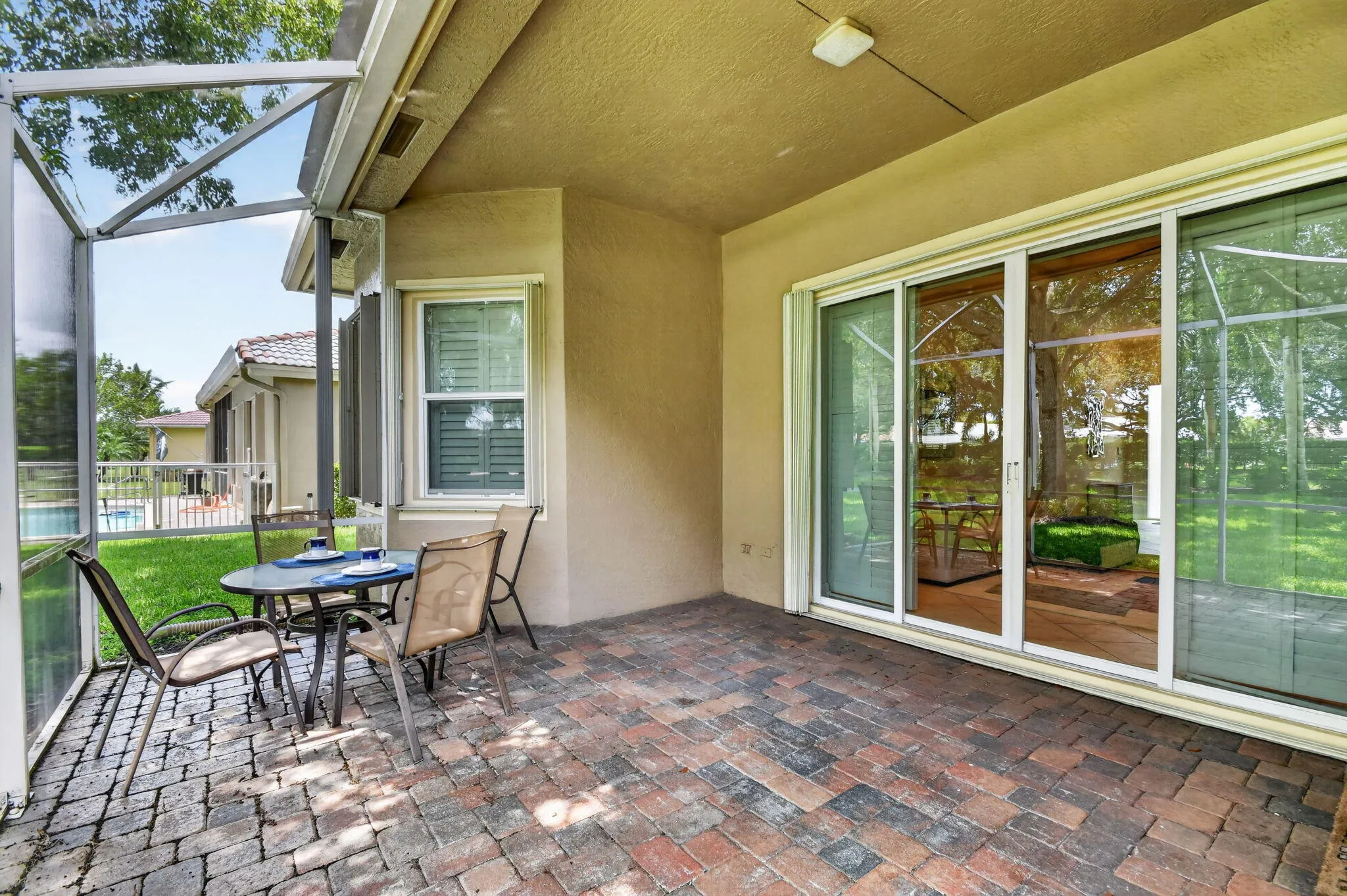 Pavered Brick-Roofed patio w/ extended screen.