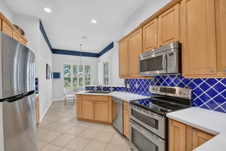 Wood panel cabinetry-full tile backsplash-stainless appliances