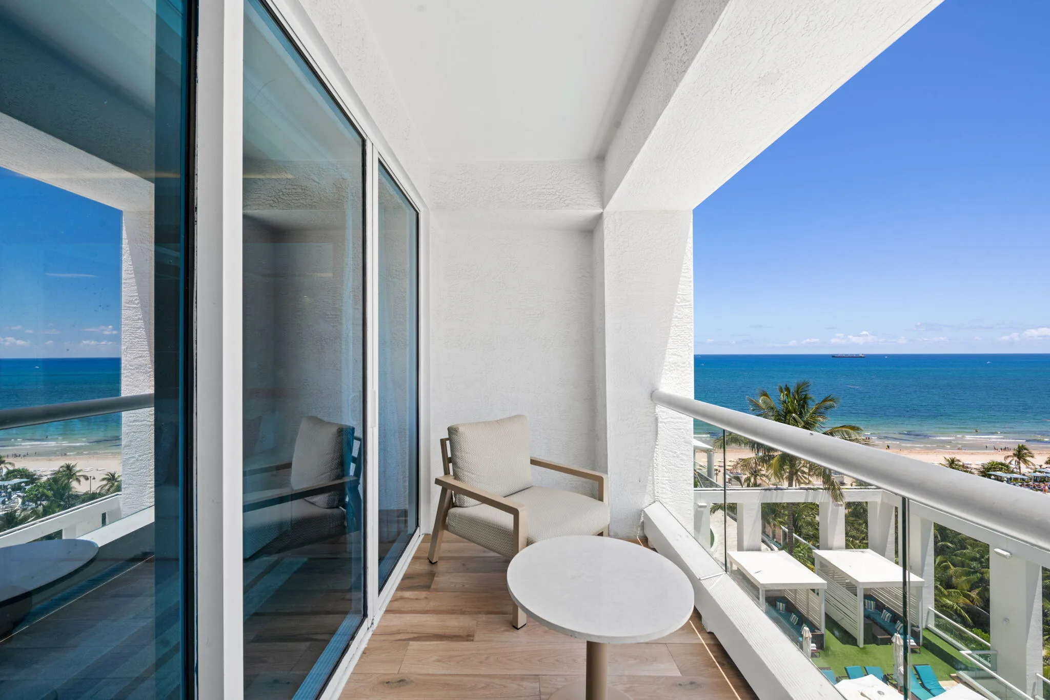 Balcony with wood-finish flooring and glass railing
