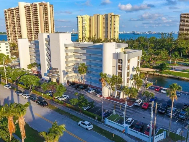 Aerial view highlighting the premier waterfront location, lush surroundings, and proximity to the bay.
