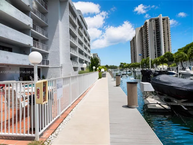 Waterfront walkway and community dock area with direct ocean-access canal views.