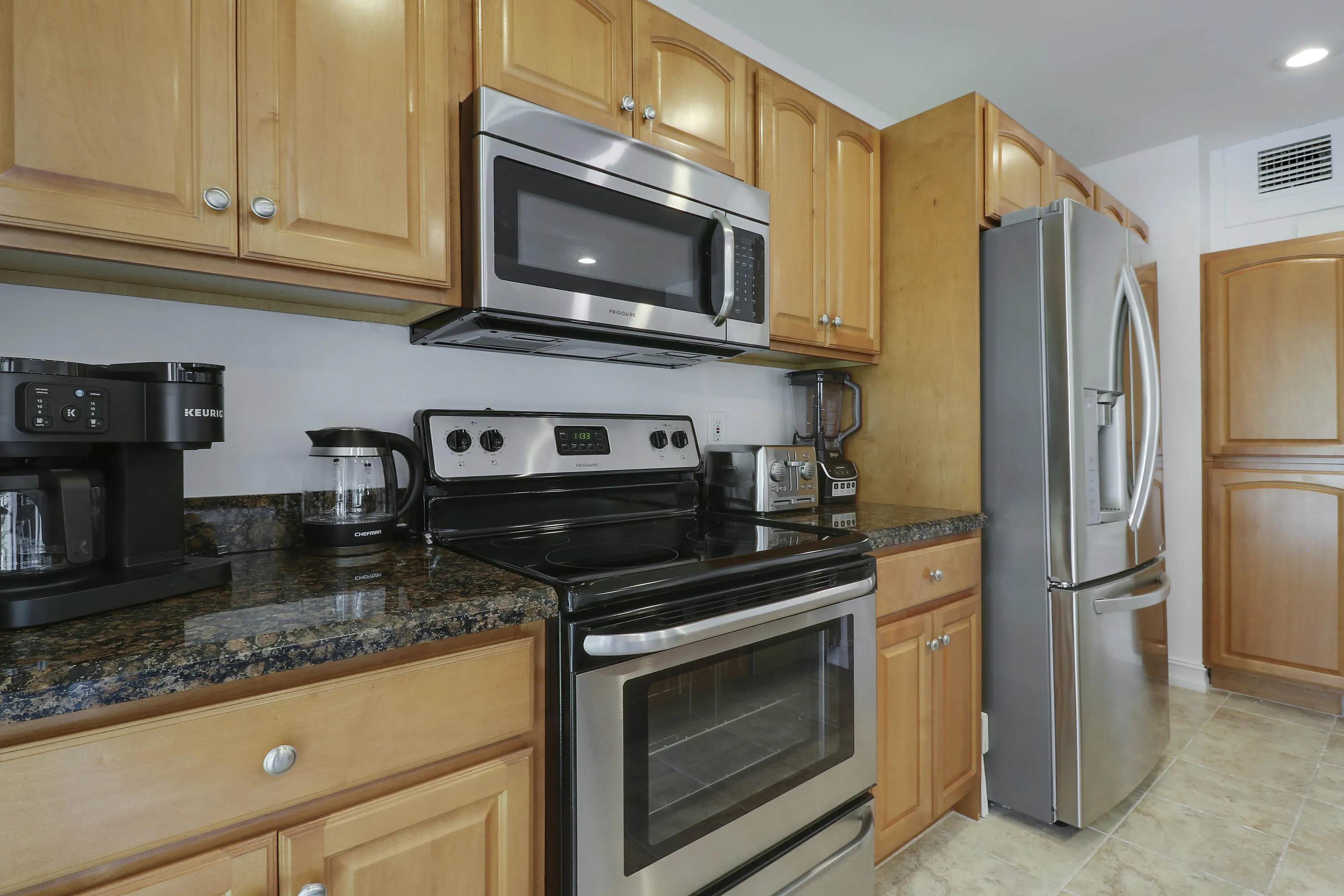 The unit has a coffee machine, tea kettle, stove, microwave and refrigerator.