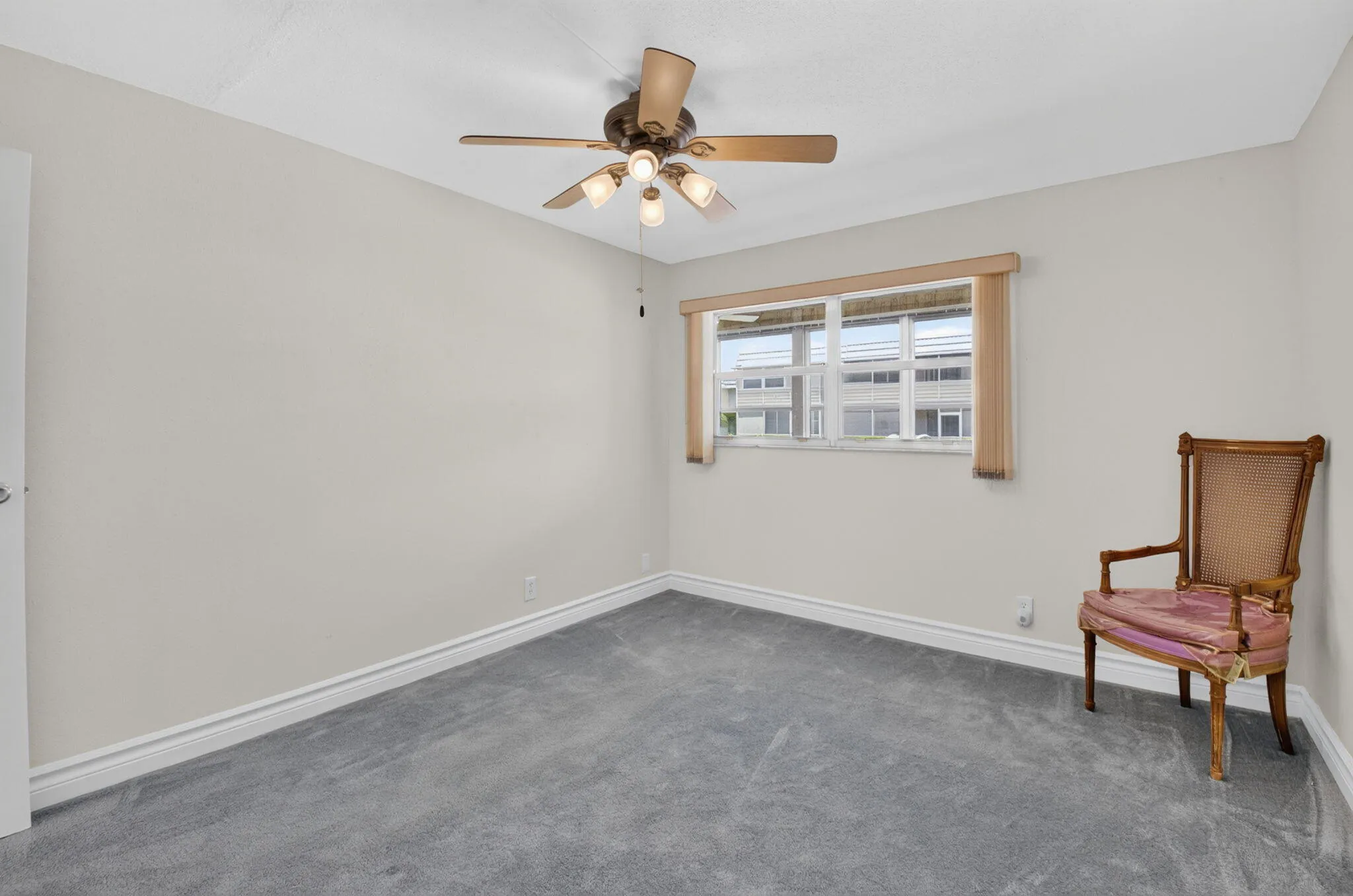 SECOND BEDROOM WITH NEW CARPET AND CEILING FAN