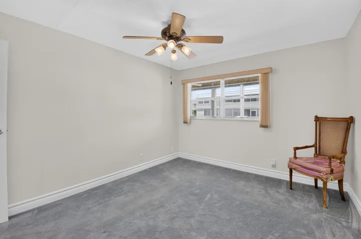 SECOND BEDROOM WITH NEW CARPET AND CEILING FAN