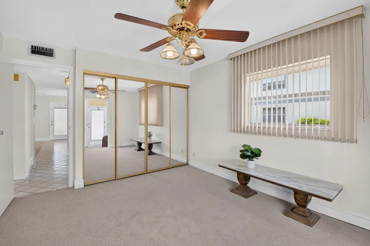SECOND BEDROOM WITH NEW CARPET AND CEILING FAN
