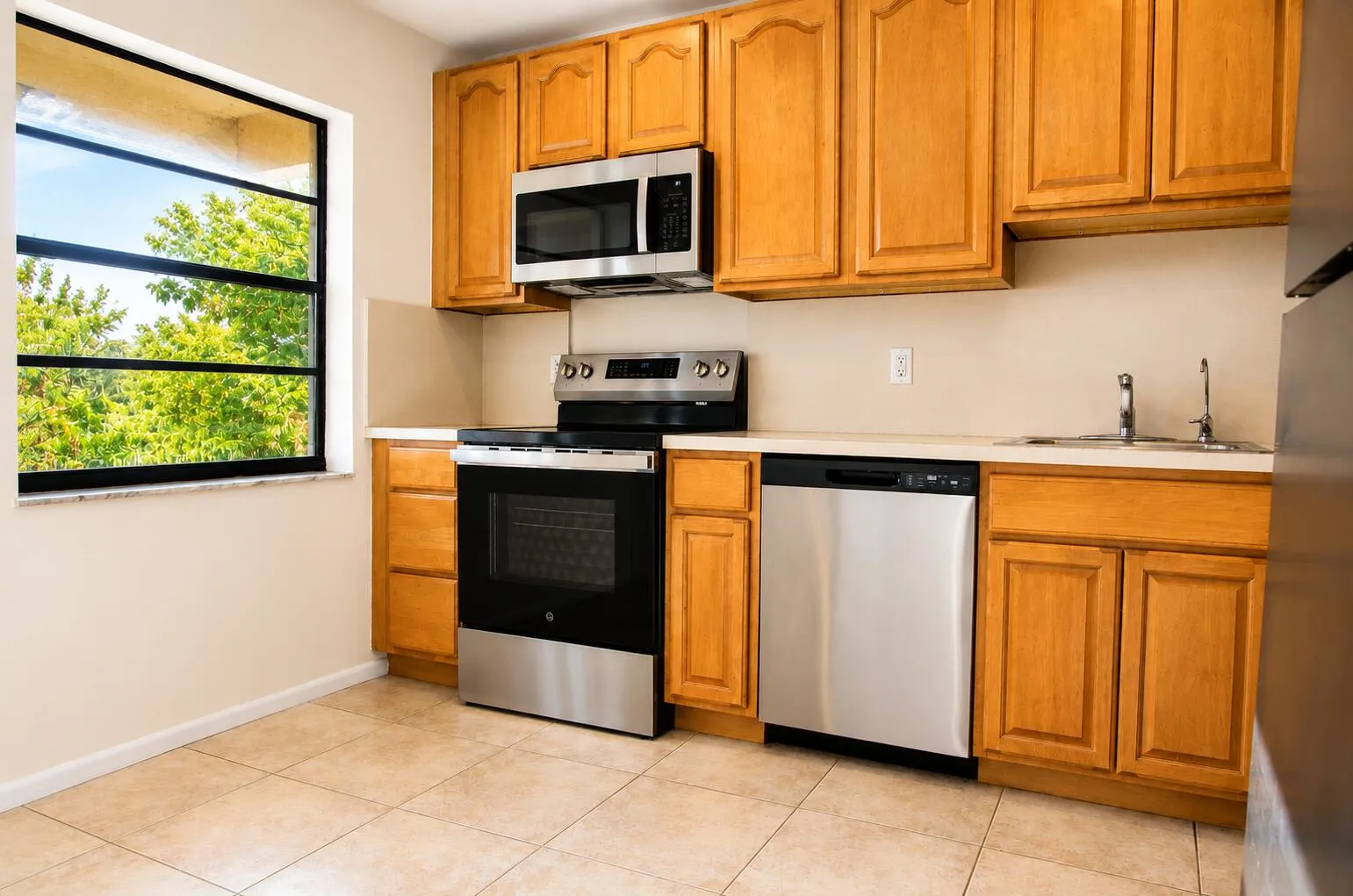With breakfast nook to left & stainless steel appliances in kitchen
