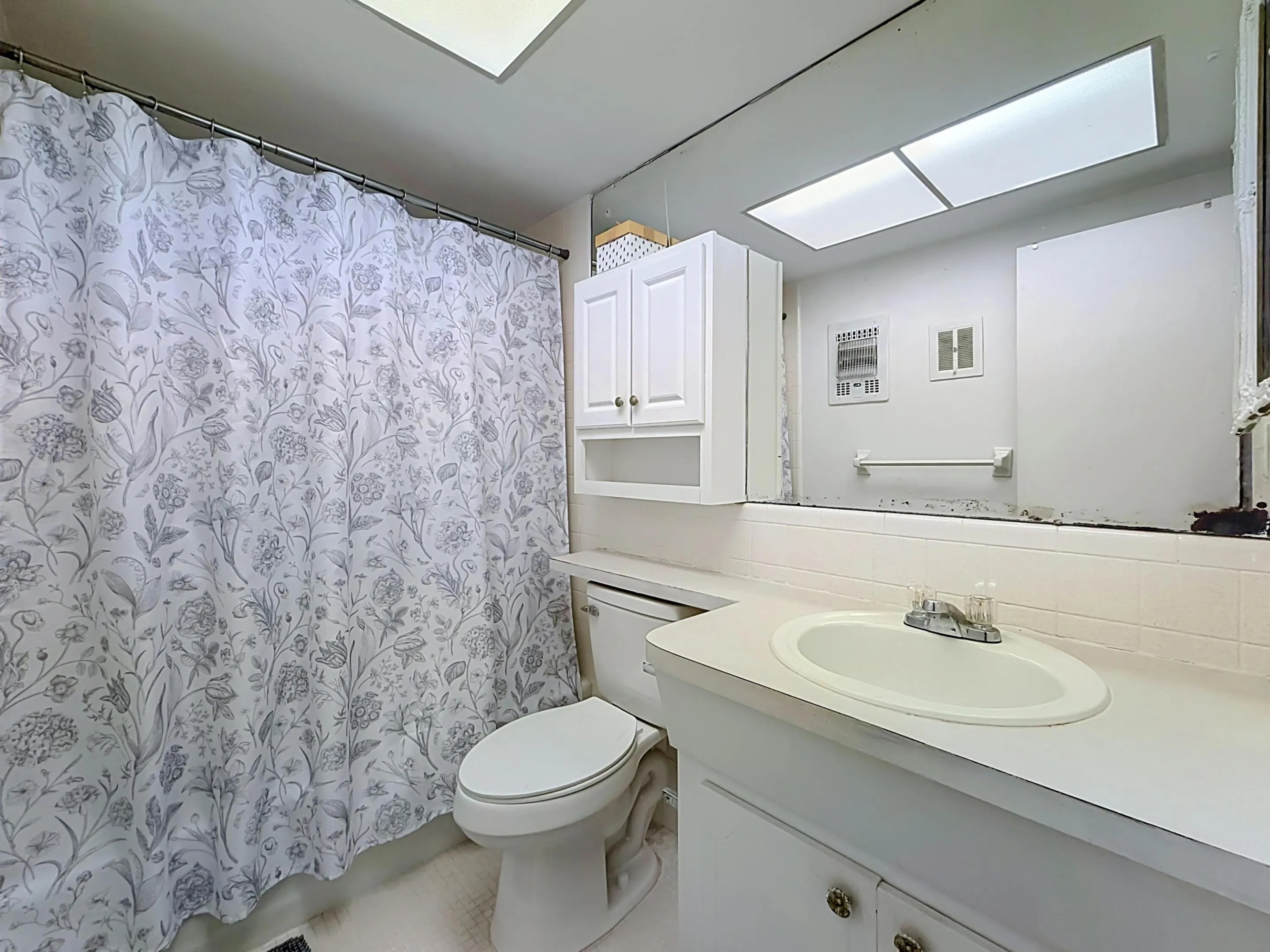 White vanity with an integrated sink and chrome faucet