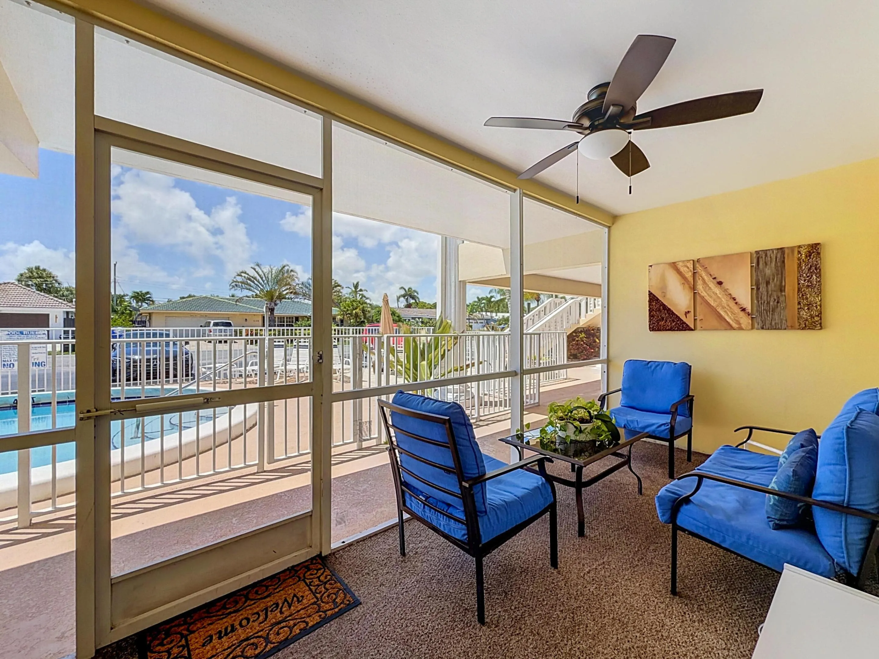 Screened-in patio with textured flooring, a ceiling fan with integrated lighting, and direct access to an outdoor pool area