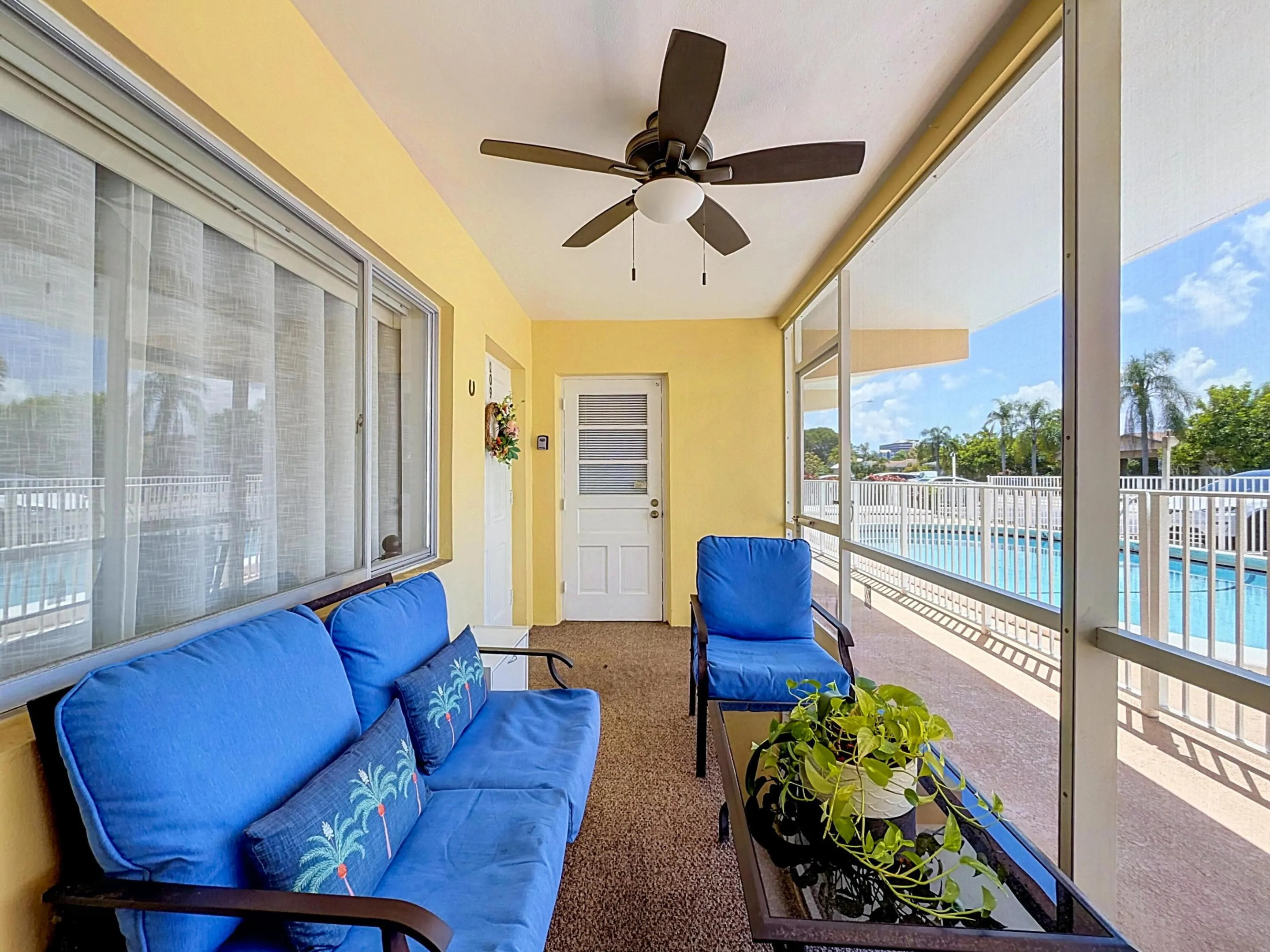 Screened patio with a ceiling fan, offering direct access to a fenced outdoor pool