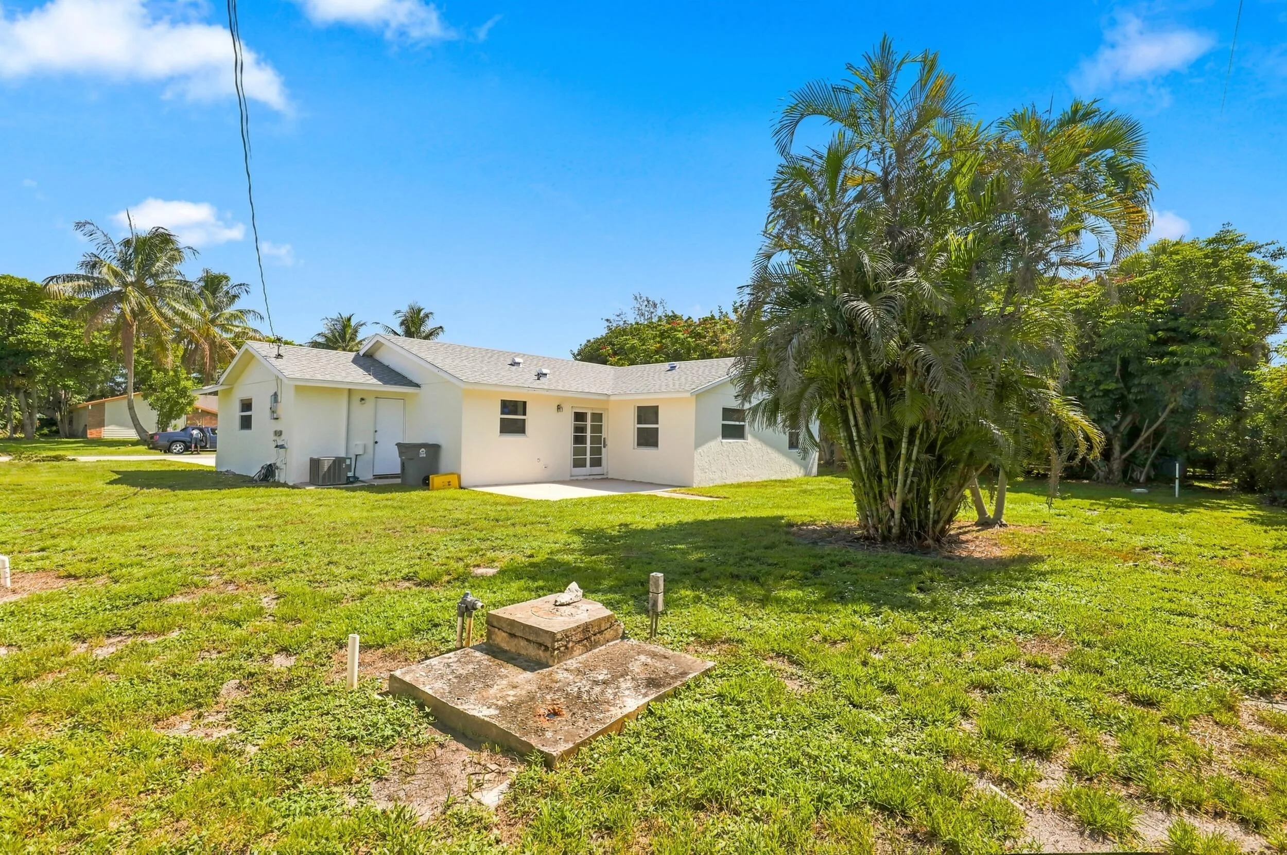 Generous grassy backyard offering plenty of outdoor space and mature landscaping.