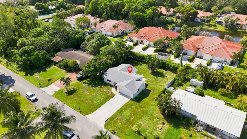 Elevated aerial view highlighting the property and its surrounding residential neighborhood.