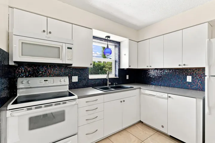 Additional kitchen view highlighting the cabinetry, counter space, and appliances.