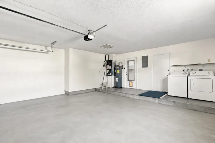 Spacious garage with utility area and room for parking and storage.