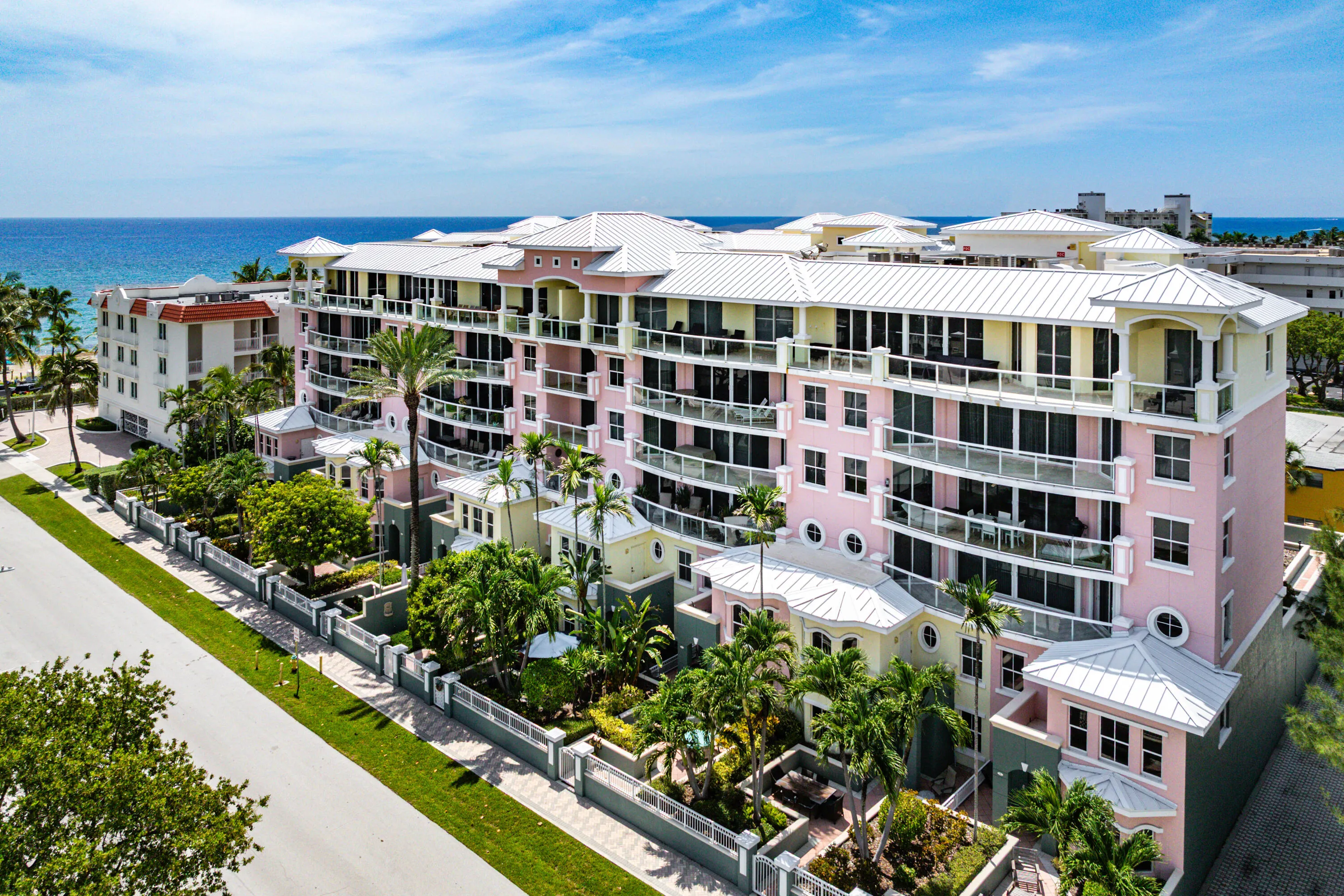Multi-story building featuring balconies, a central courtyard, and an exterior with varied architectural elements