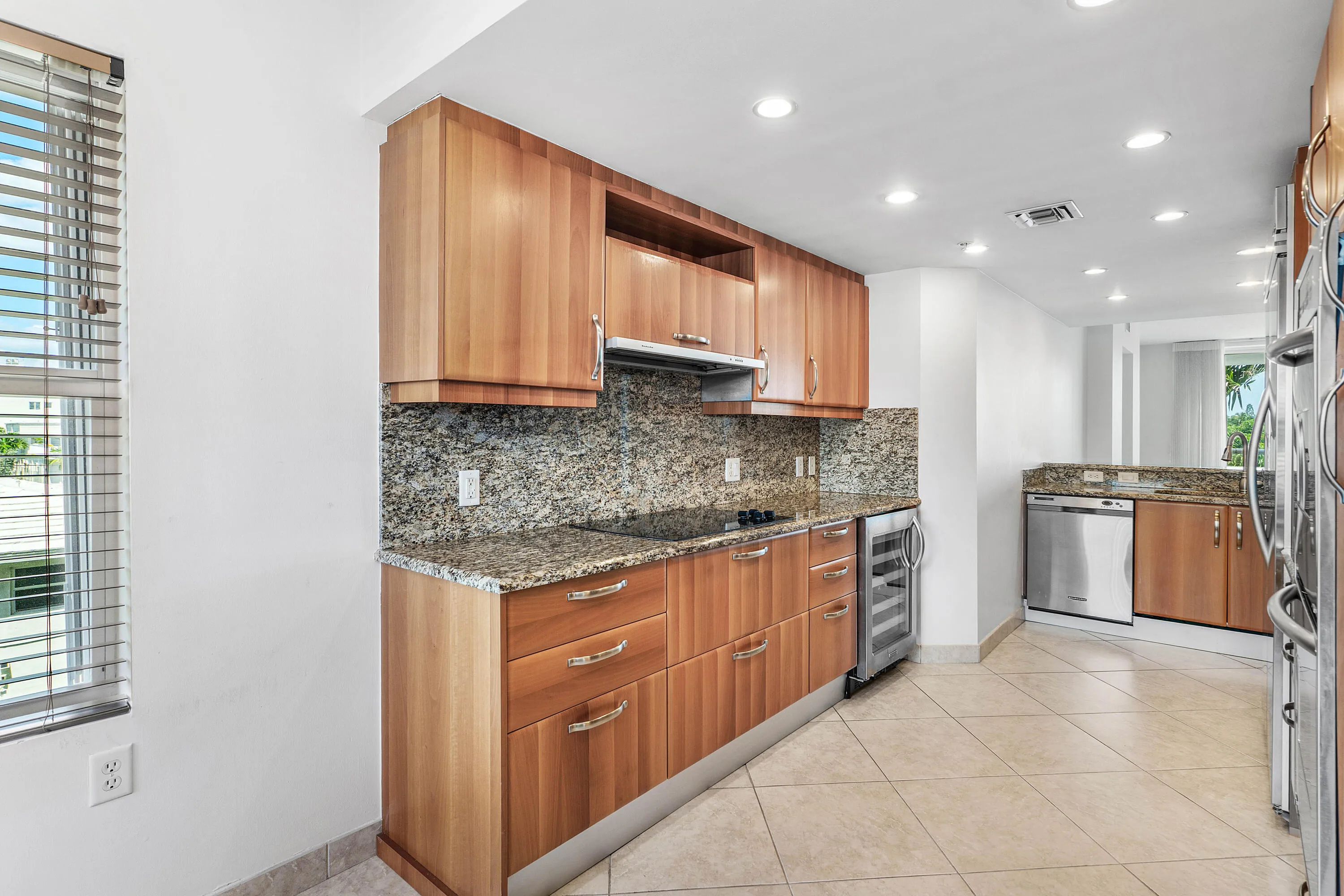 Integrated cooktop, stainless steel wine refrigerator, and recessed lighting