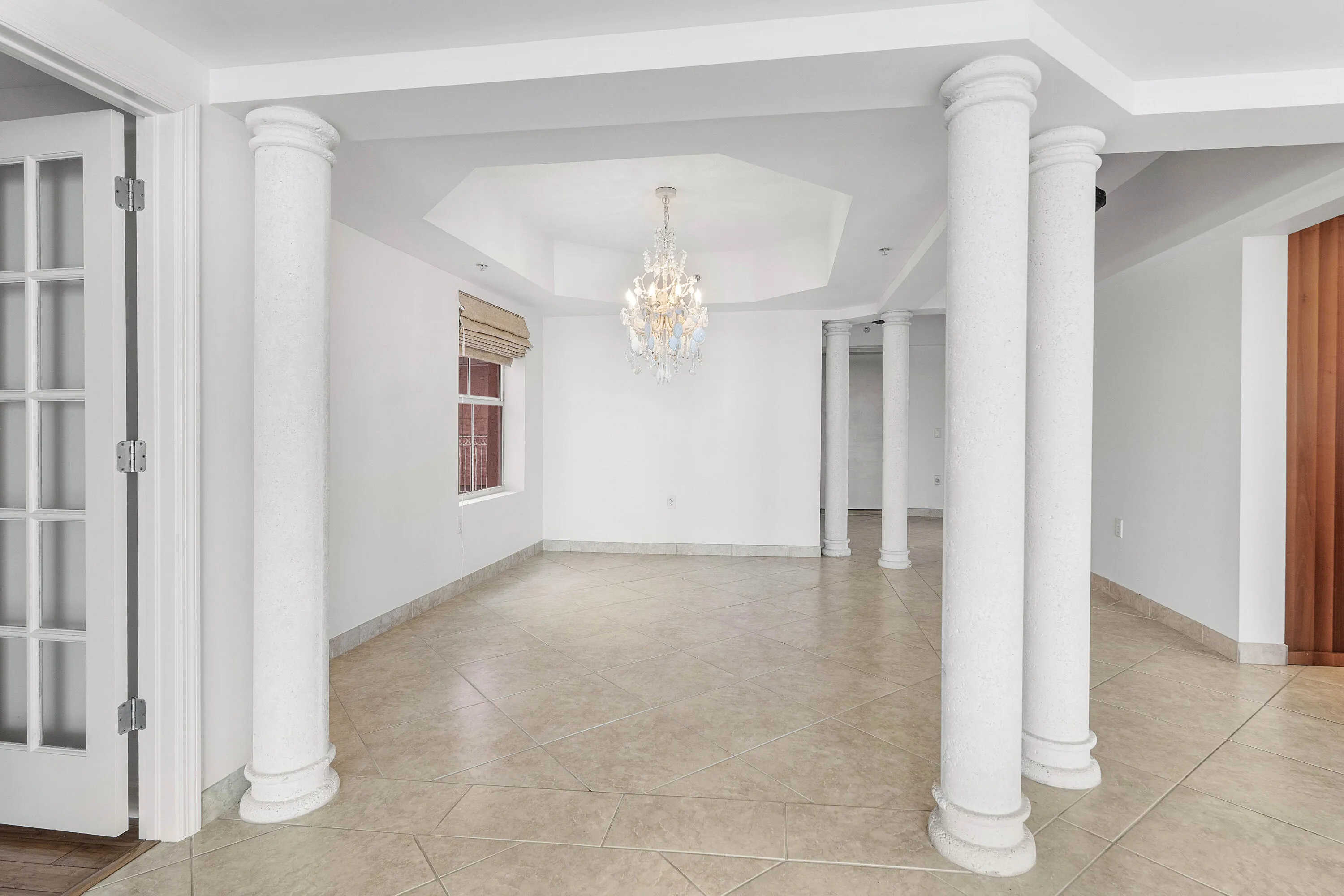 Tiled flooring, architectural columns, coffered ceiling,