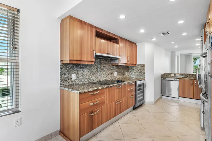 Integrated cooktop, stainless steel wine refrigerator, and recessed lighting