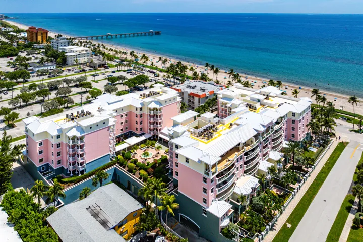 Coastal properties featuring direct beach access, balconies, and lush landscaping