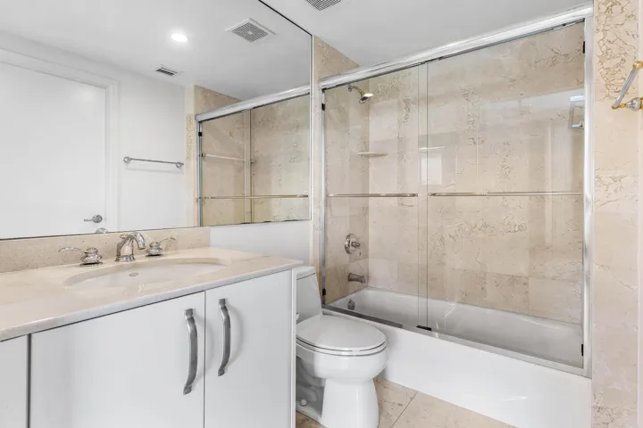 Vanity with integrated sink, polished chrome faucet, and white cabinetry