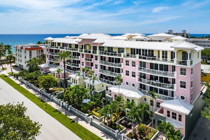 Multi-story building featuring balconies, a central courtyard, and an exterior with varied architectural elements
