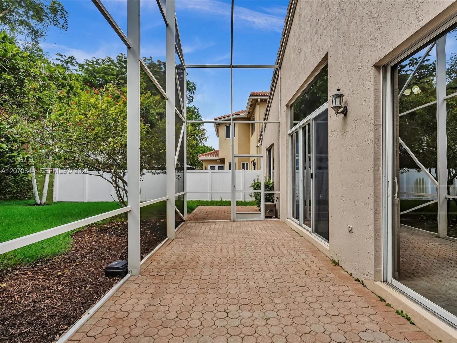 Expansive screened-in patio creating an ideal outdoor living space for relaxing or entertaining all year round.
