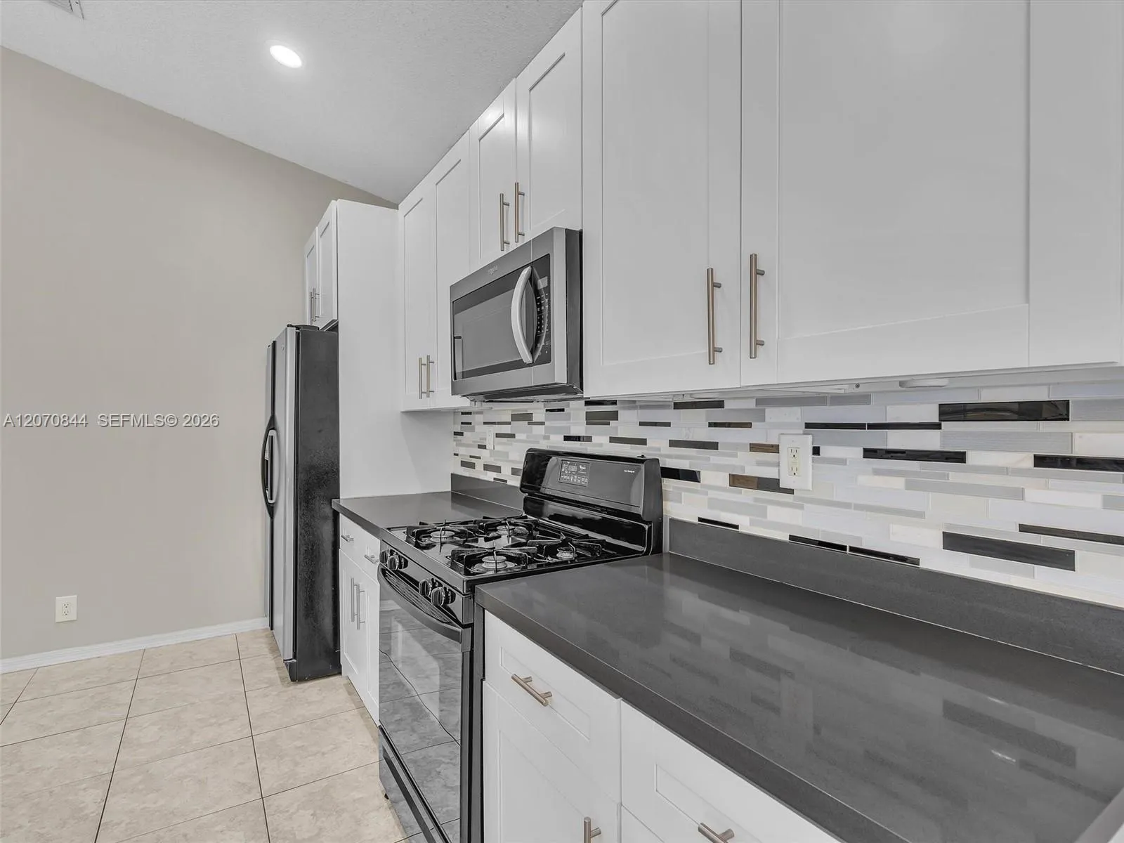 The kitchen layout provides ample workspace meal preparation and features a gas stove for effortless cooking.