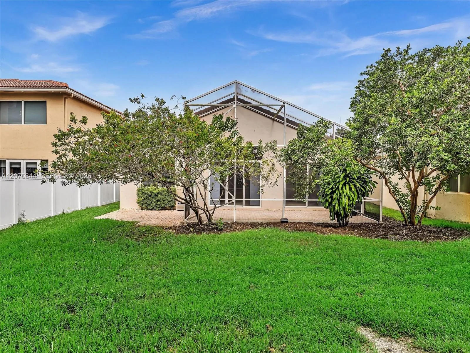 Private, open backyard with lots of green space and mature trees providing natural shade, all with no rear neighbors for added privacy and tranquility.