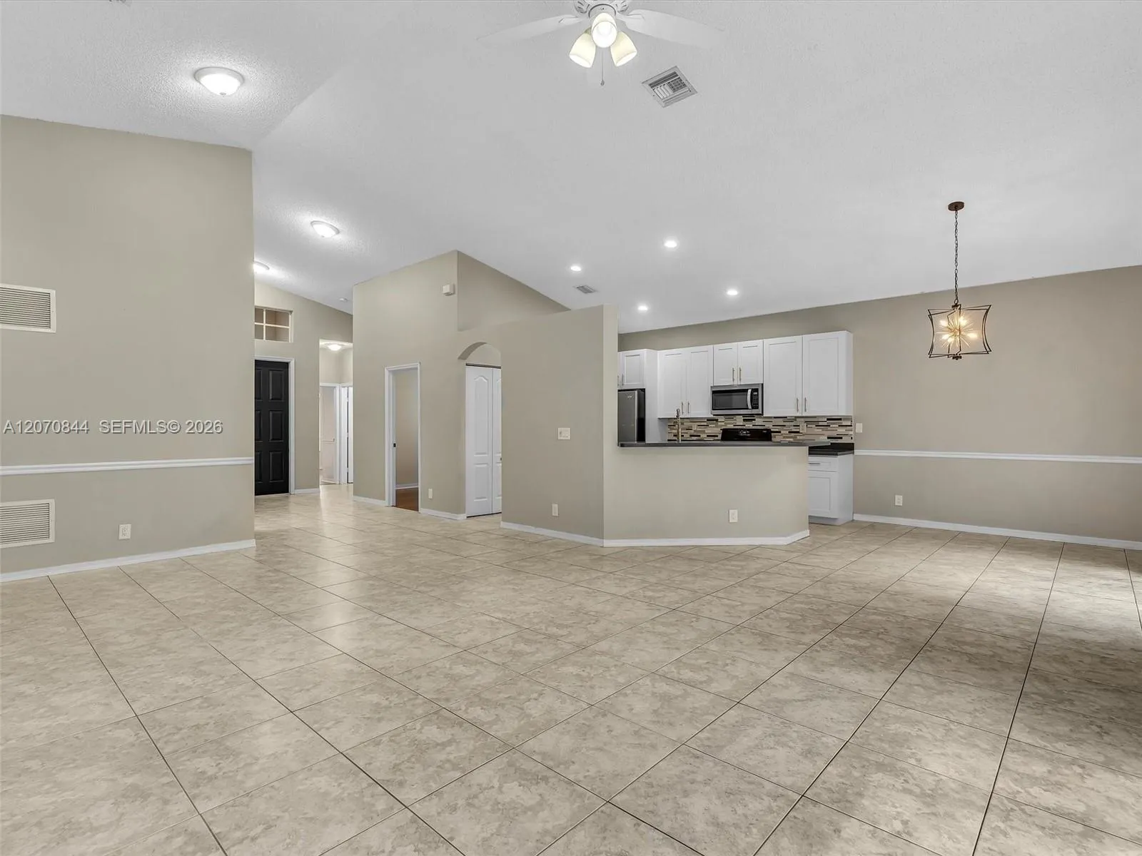 Open concept floor plan designed for effortless flow between the living, dining, and kitchen areas.