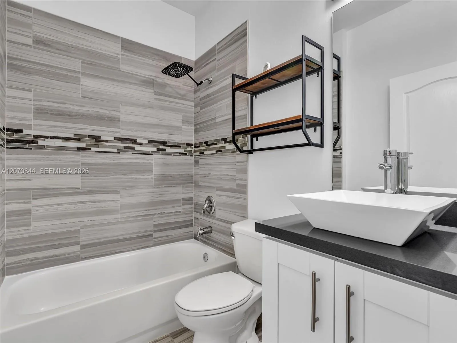 Second fulll bathroom featuring a tub/shower combination, elegant quartz countertops, ample storage space, and convenient linen closet for added functionality