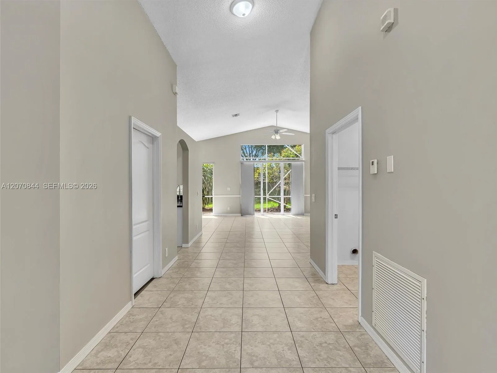 Grand entryway welcomes you into the home with a bright, open foyer that flows seamlessly into the main living space, creating an inviting first impression from the moment you walk inside.
