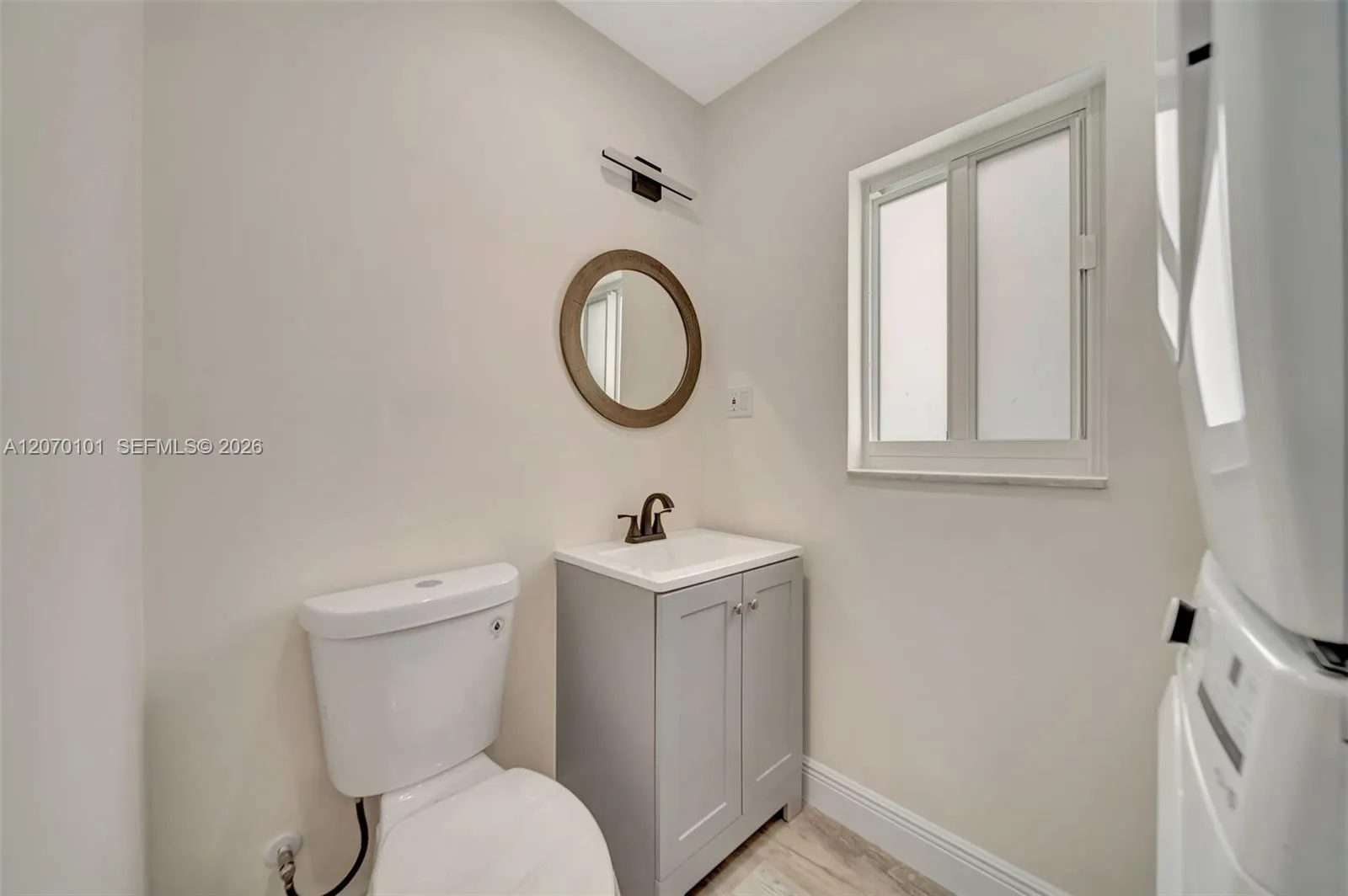 Toilet, vanity, mirror, window