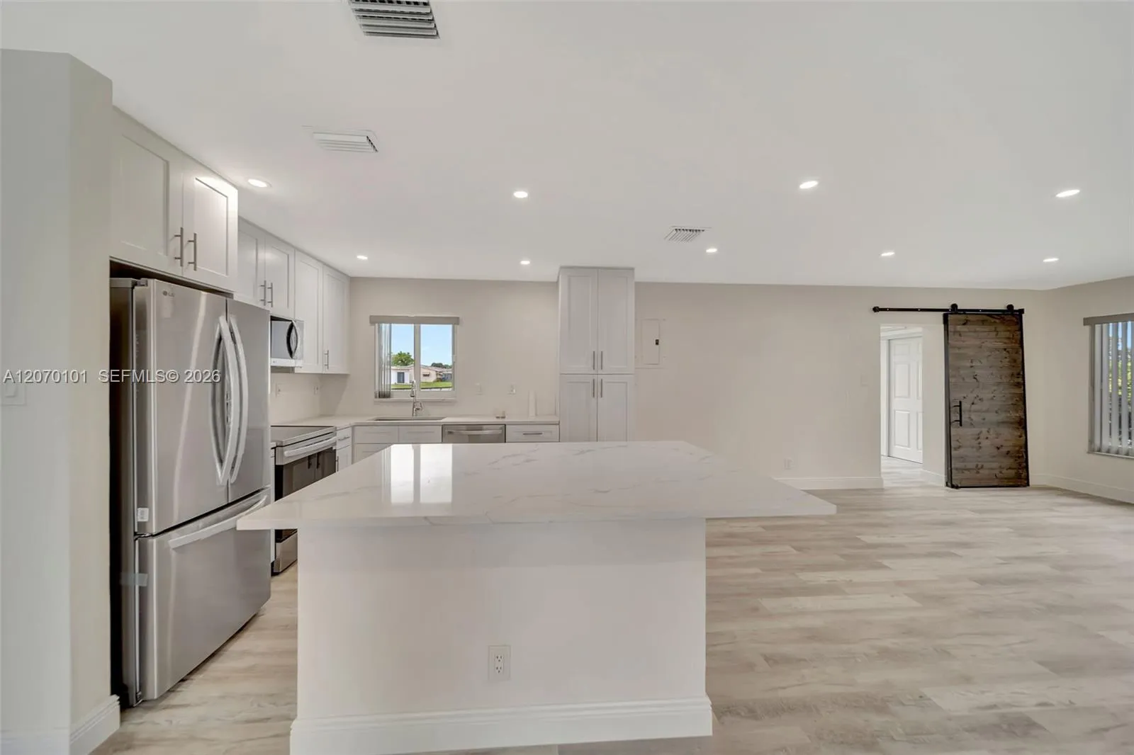 From living room, island + fridge/stove
