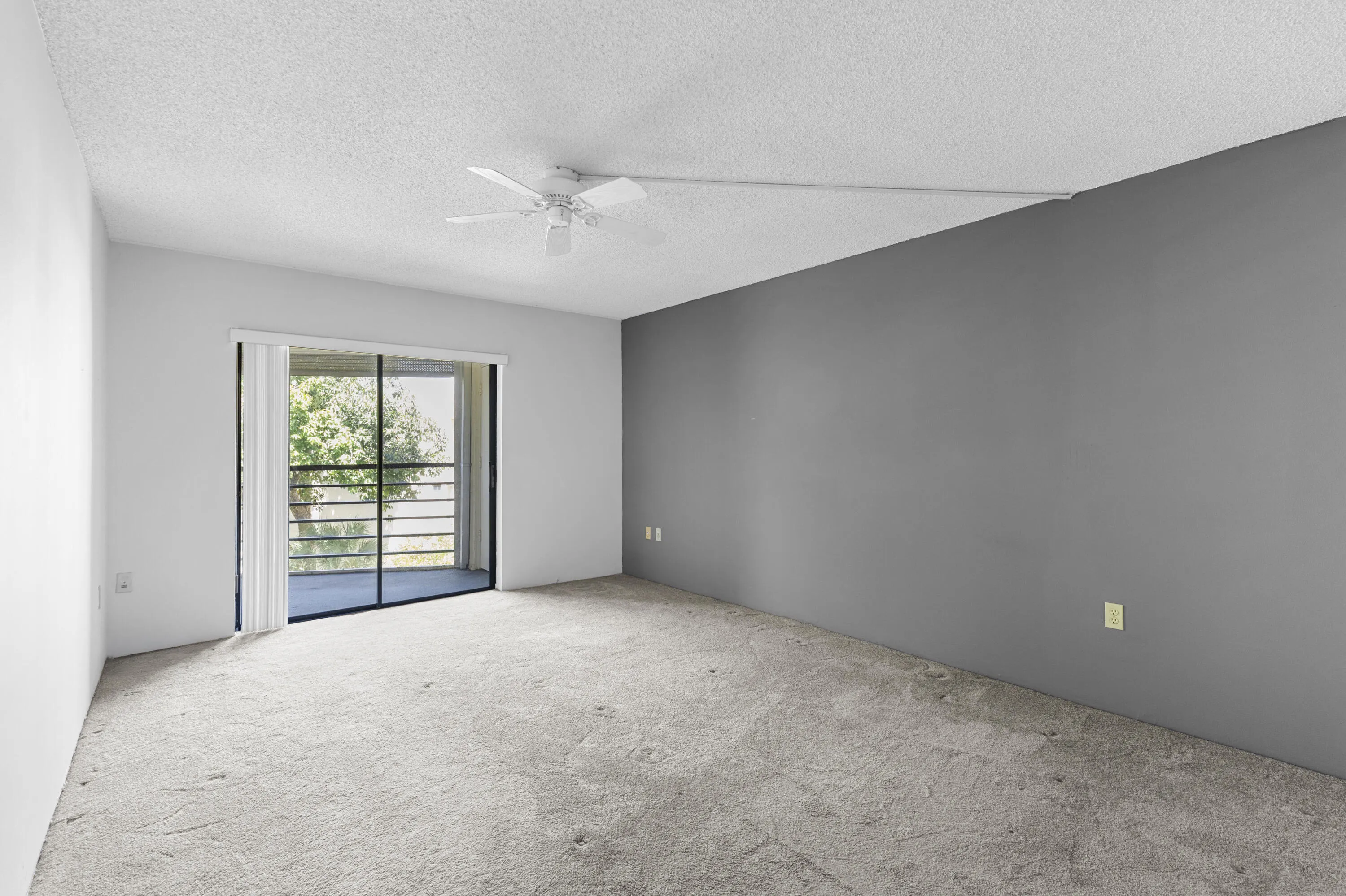 Very large primary bedroom with sliders that open up to the balcony