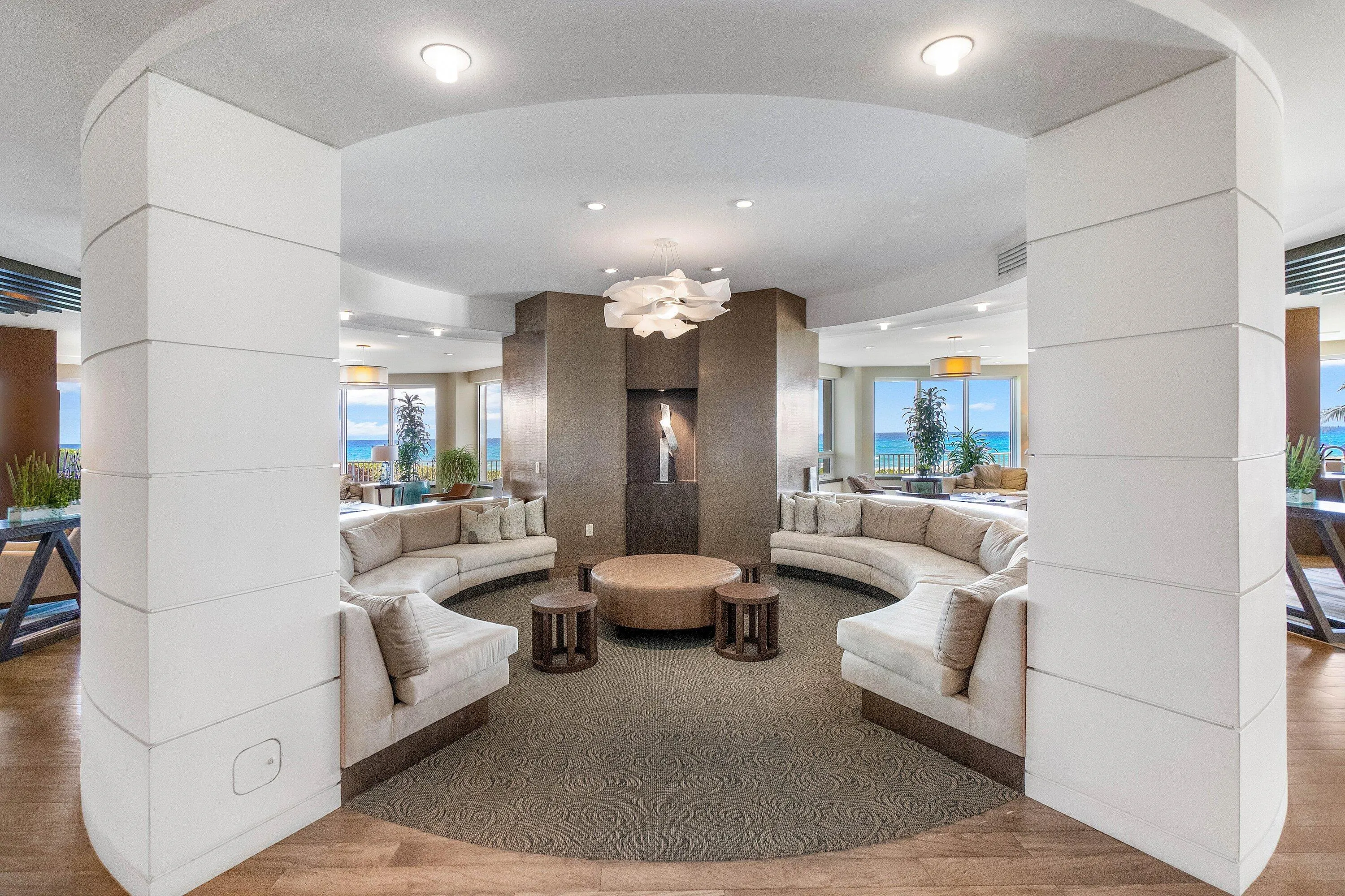 Circular seating area featuring recessed lighting, a modern chandelier, and wood-finish flooring