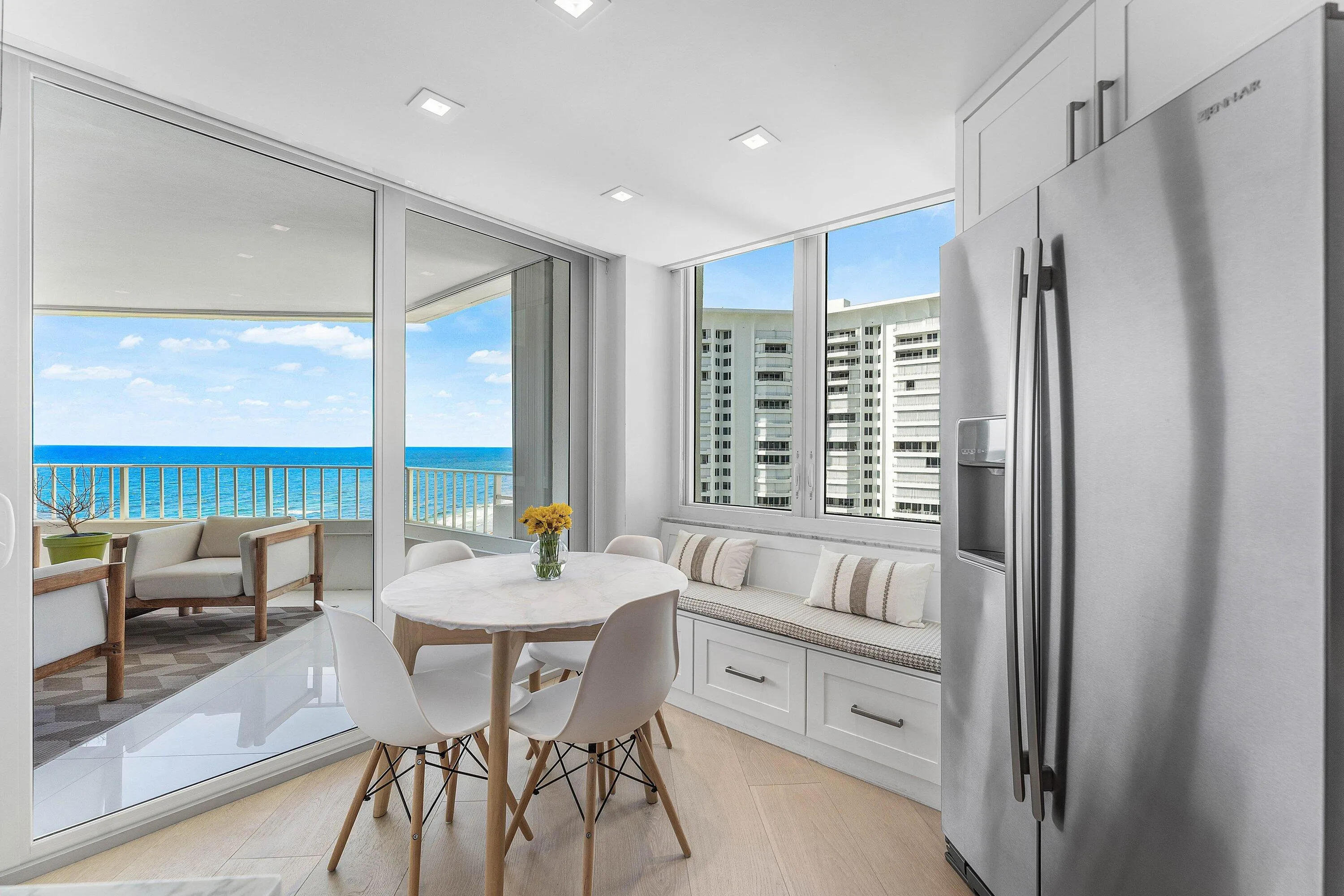 Expansive glass sliding doors open to a balcony