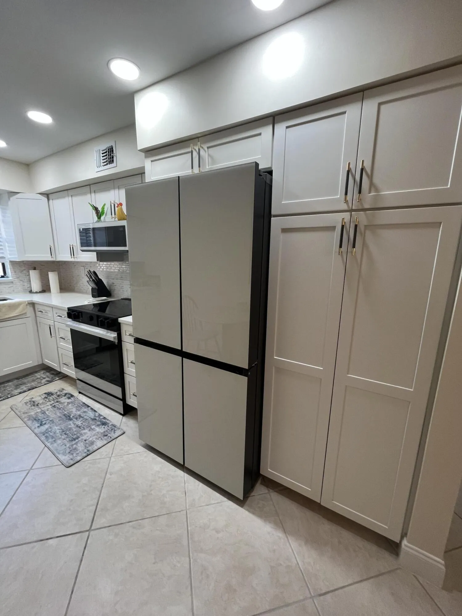 matching cabinetry includes the kitchen pantry