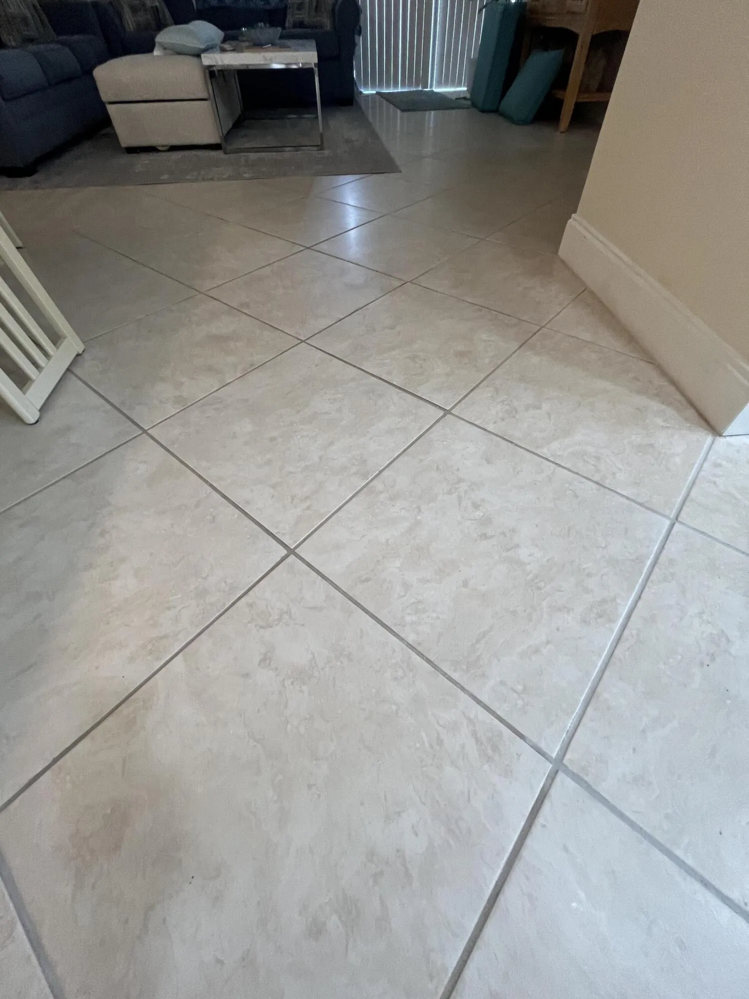 TILED ON DIAGONAL NEUTRAL COLORED flooring throughout the condo.