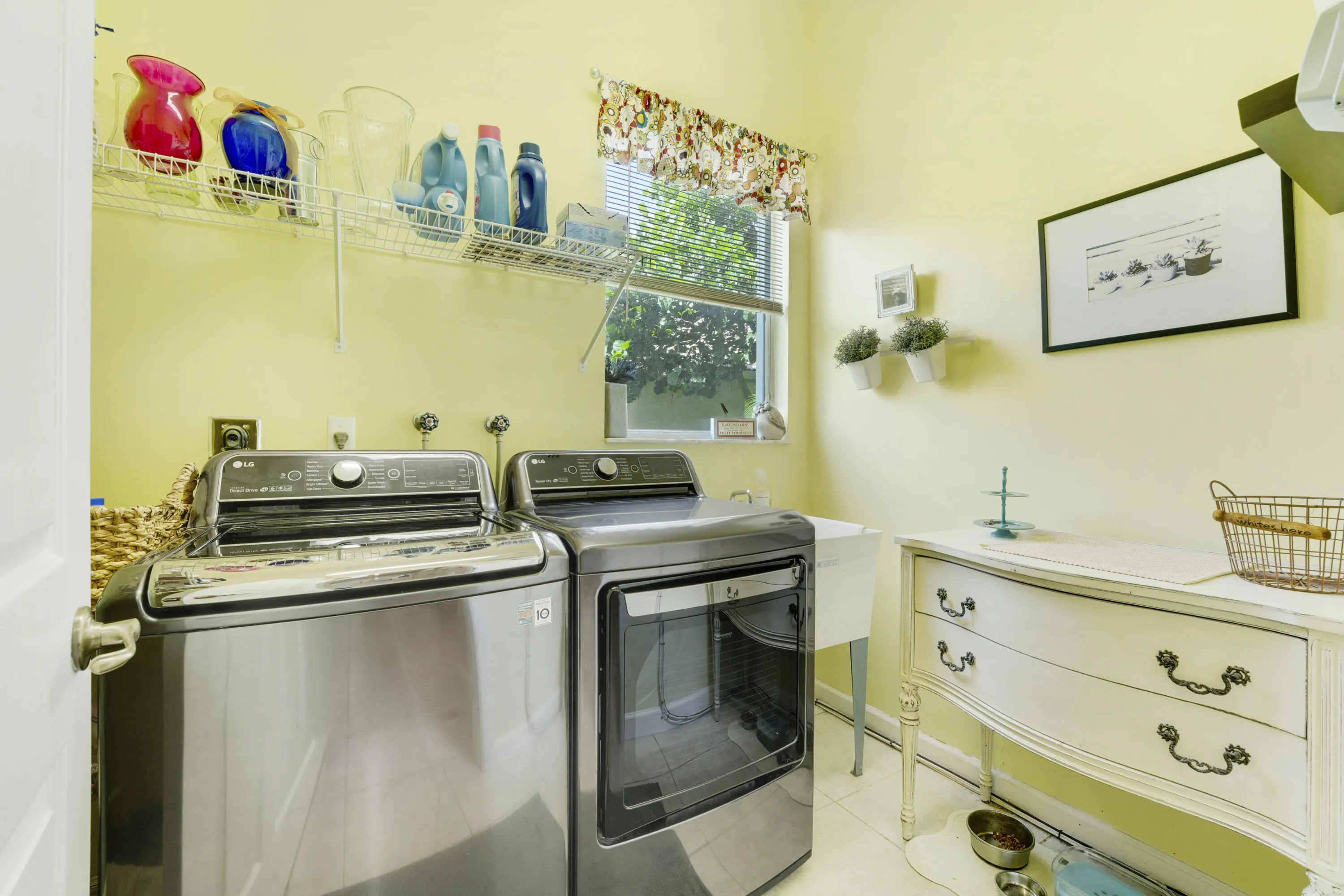 Separate laundry room with utility sink, window and additional storage space