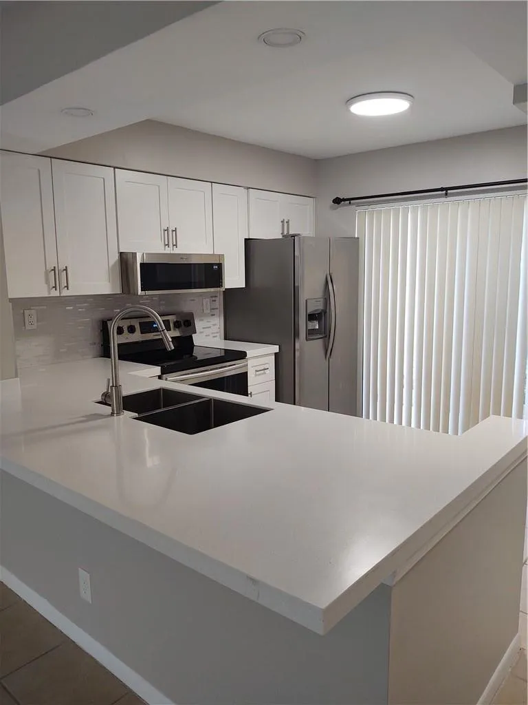 Extended quartz counters for breakfast bar.