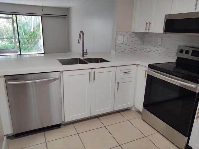 Kitchen with stainless appliances, quartz counters and soft close cabinets