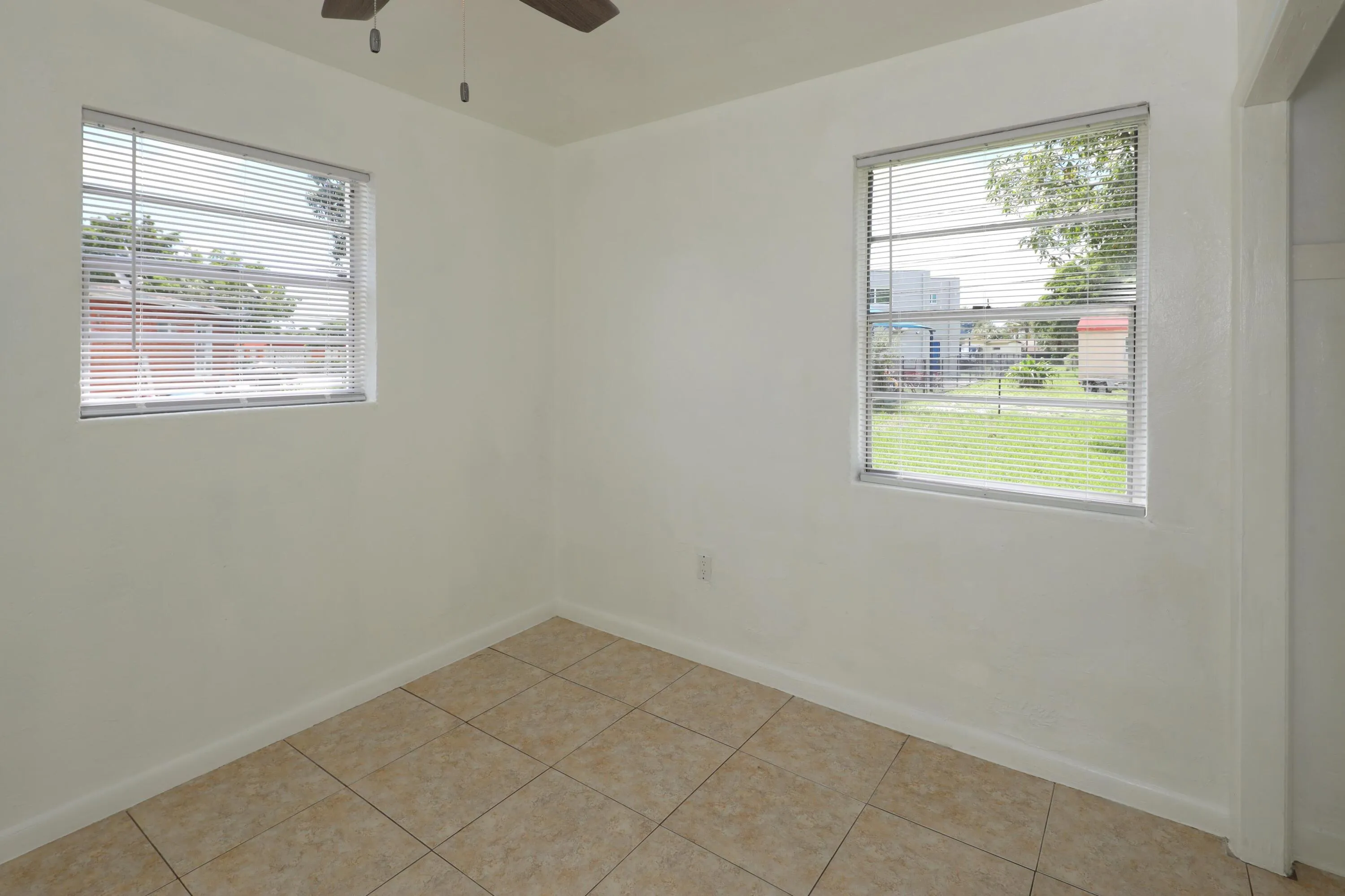 Light and bright bedroom with ample natural light, tile flooring and brand new window shades. Move in and add your own colors and personal style.