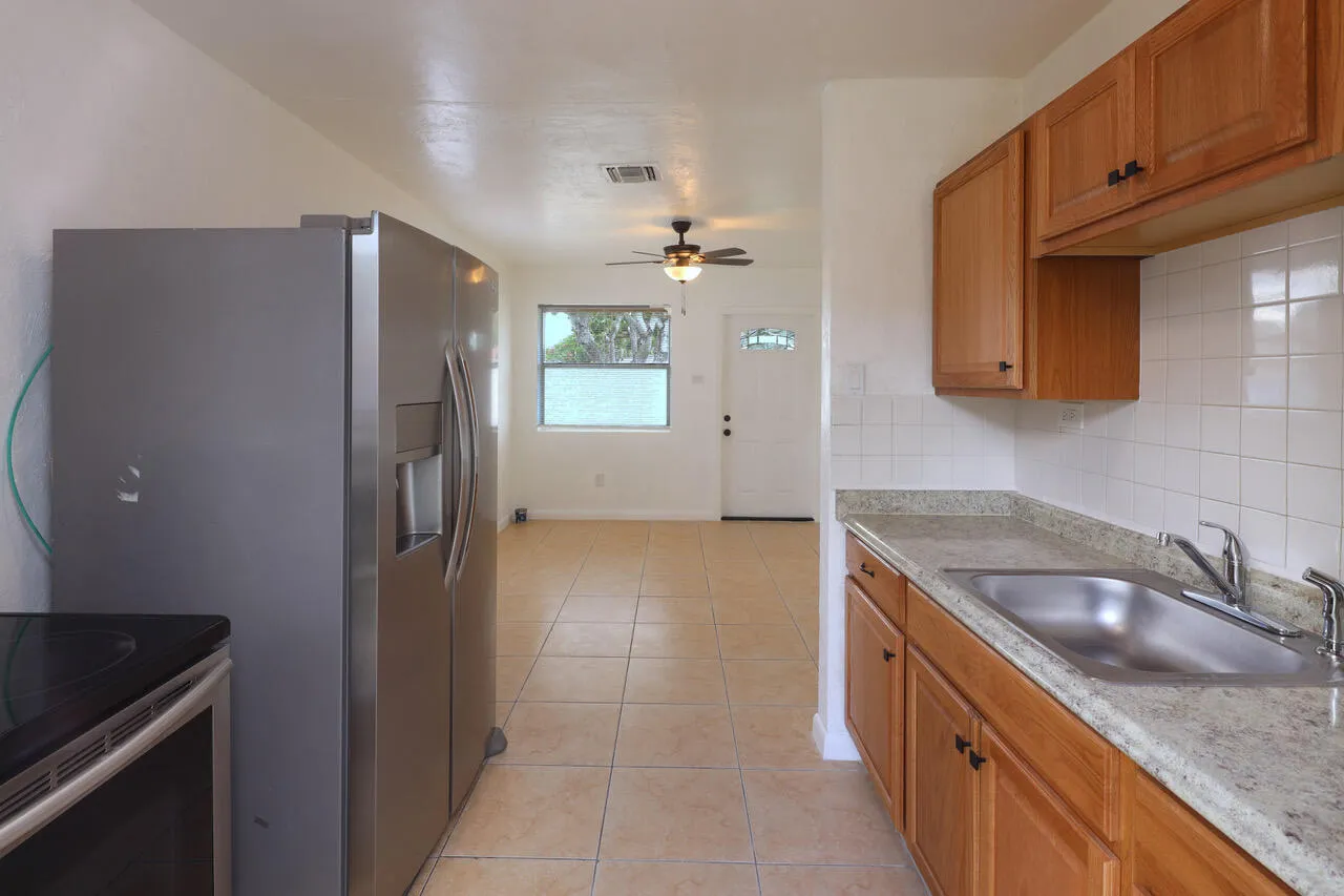 Kitchen view toward the living room highlights the practical floor plan, new kitchen cabinets and easy flow between the main living spaces.