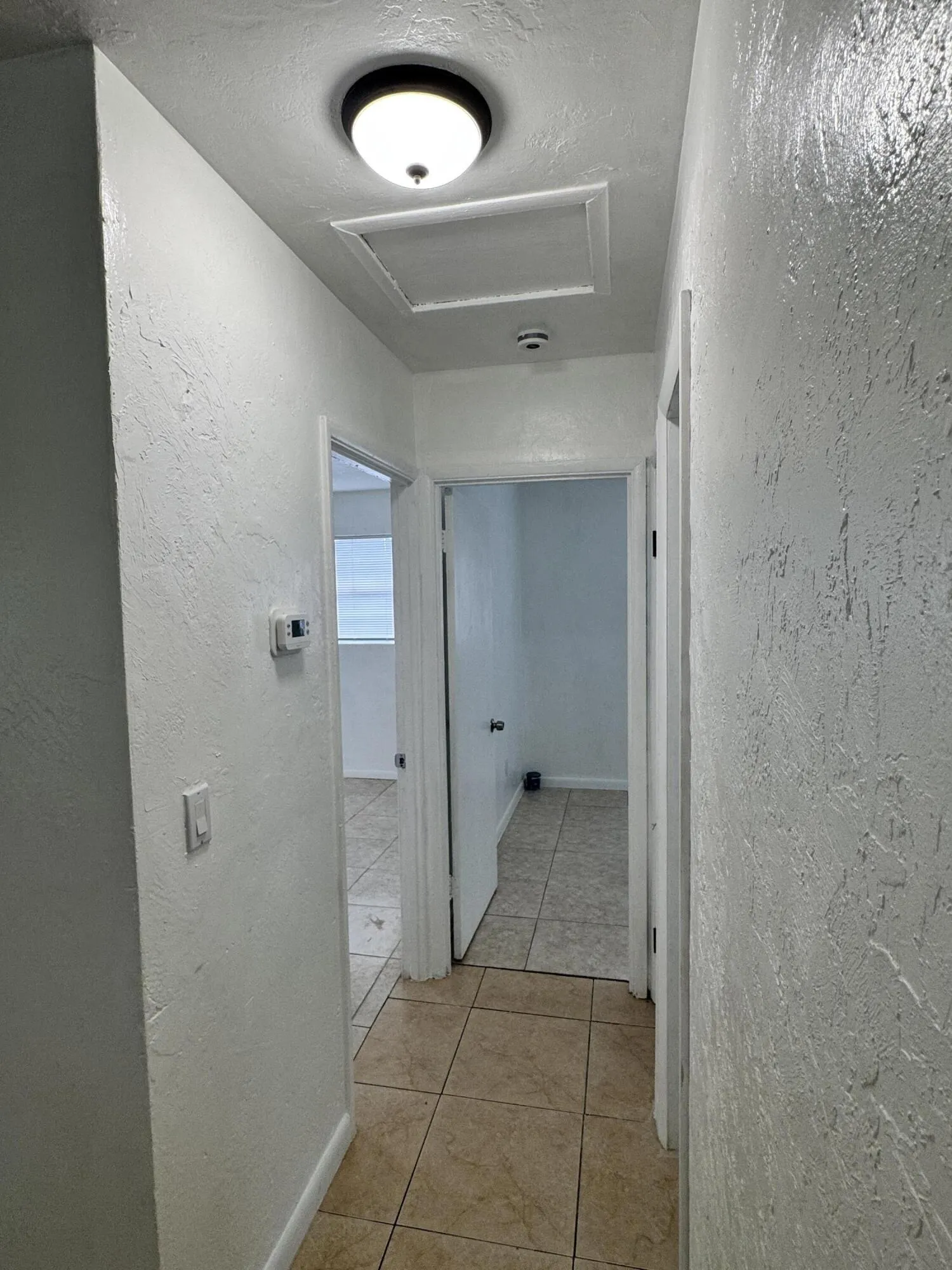 Bright interior hallway with ample lighting connects the living areas, bedroom and bathroom in this comfortable and easy to maintain Fort Lauderdale home.