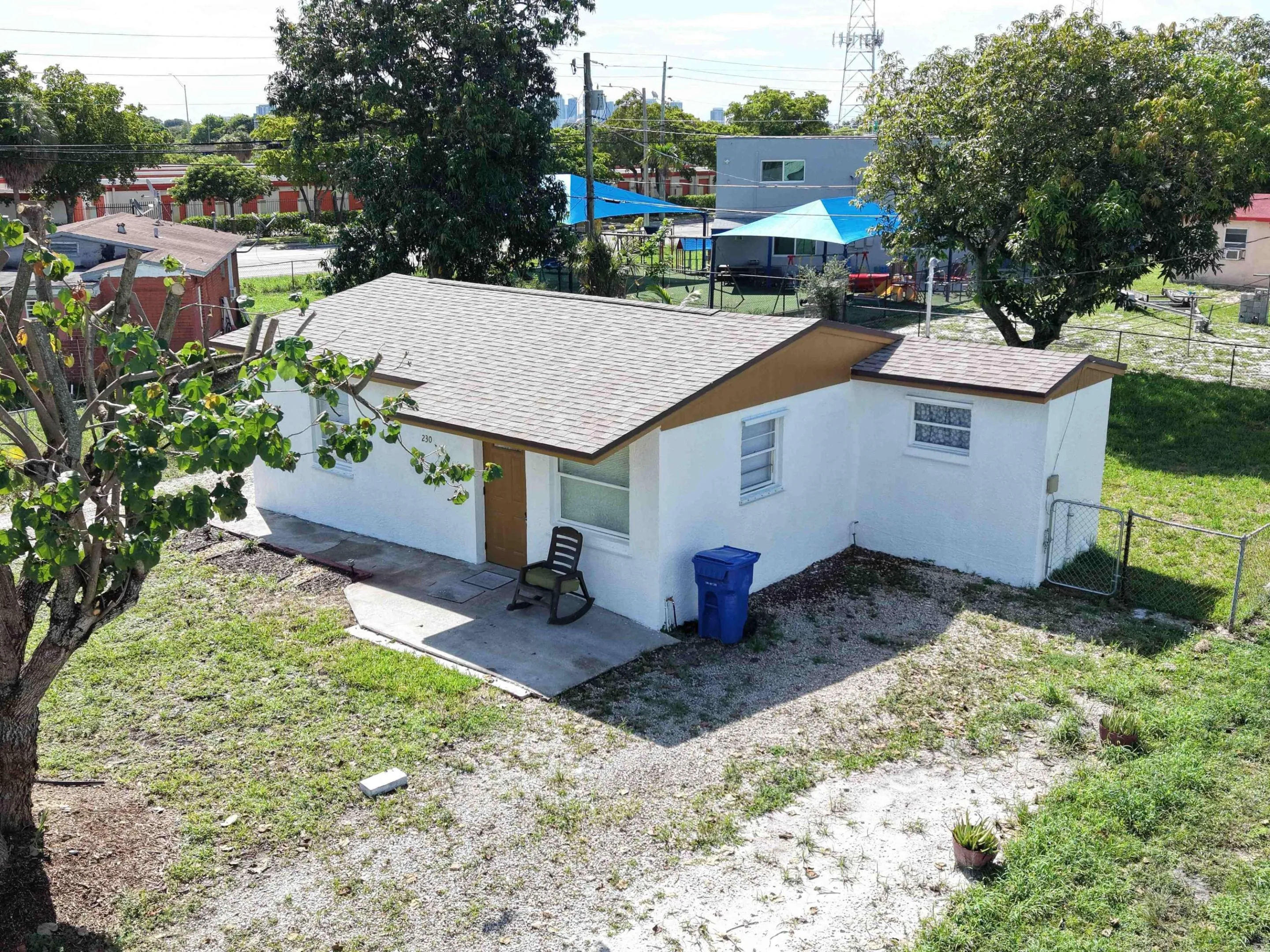 Aerial view highlights the brand new roof, hurricane panel protection and generous lot. Major improvements are already completed on this affordable Fort Lauderdale home.