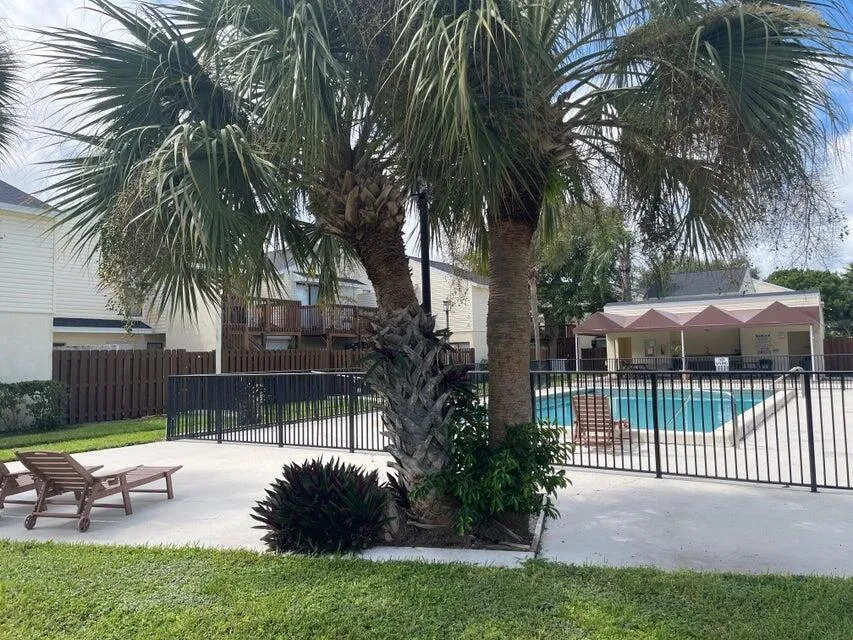 QUITE A FEW LOUNGE CHAIRS SET UP AROUND THE POOL TO RELAX ON AND SUNBATHE