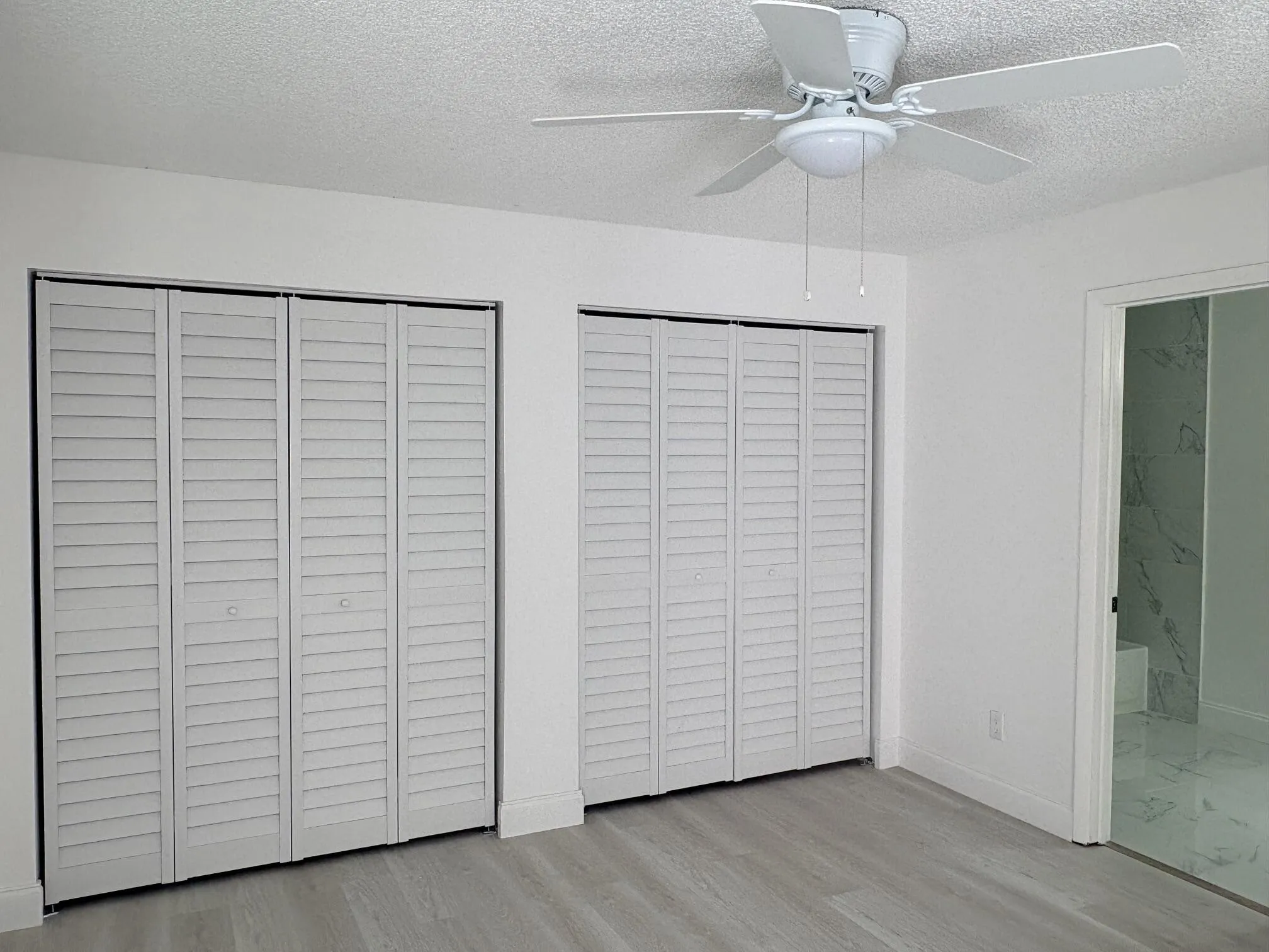 BEHIND THESE DOORS IS QUITE A BIT OF CLOSET SPACE, ON THE RIGHT SIDE IS THE WATER HEATER